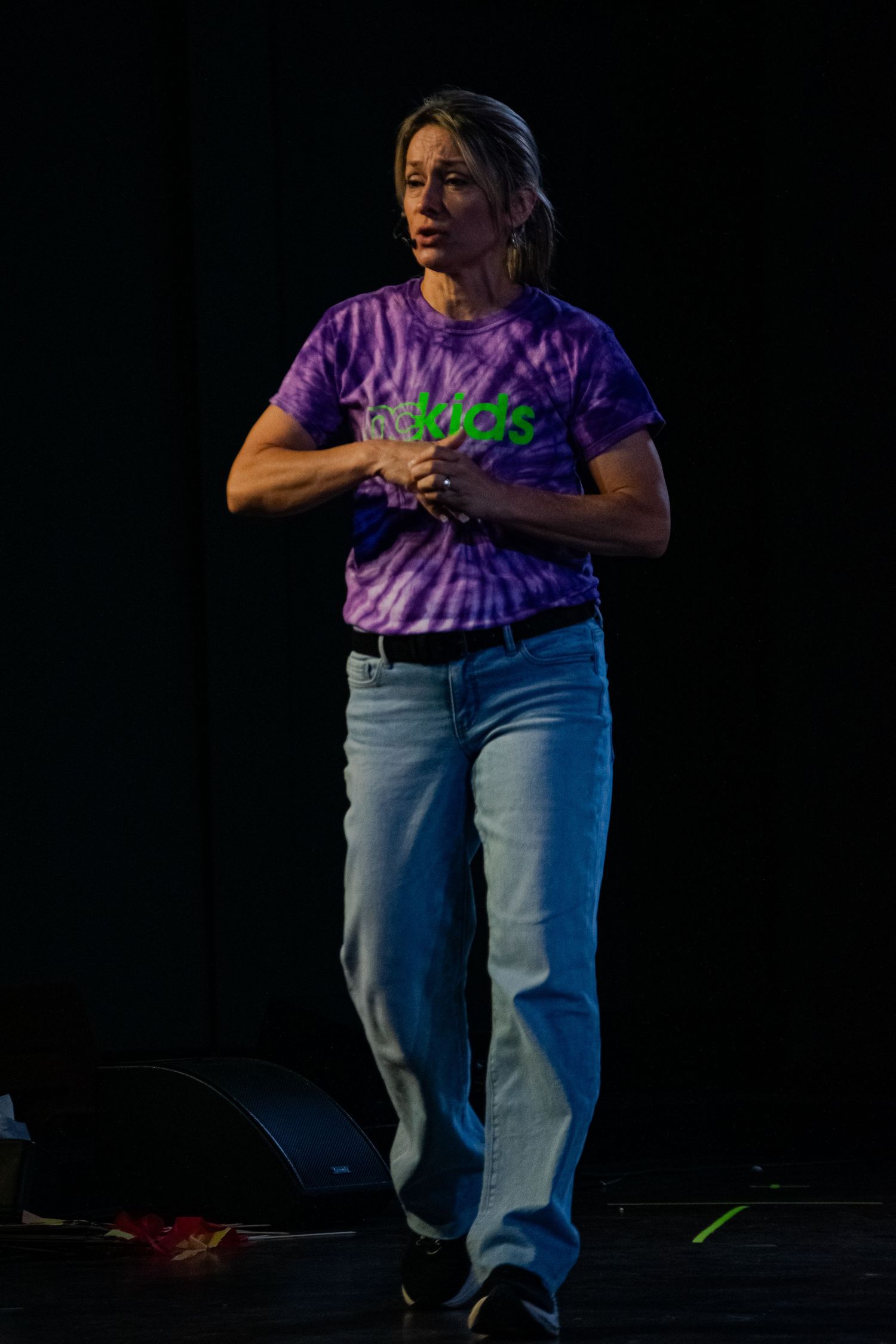 A woman walking across a stage