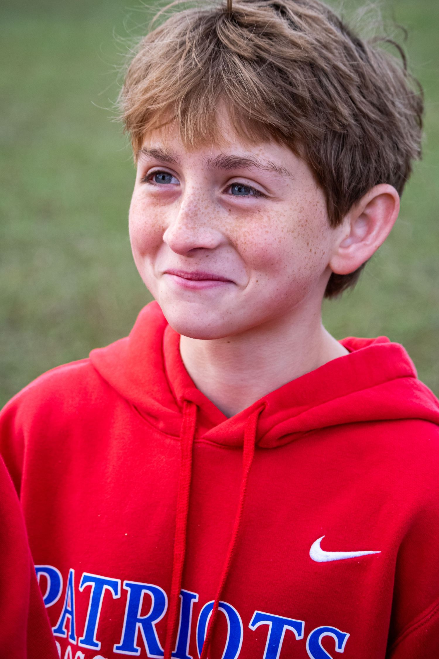 A photo of a man smiling and looking to the side