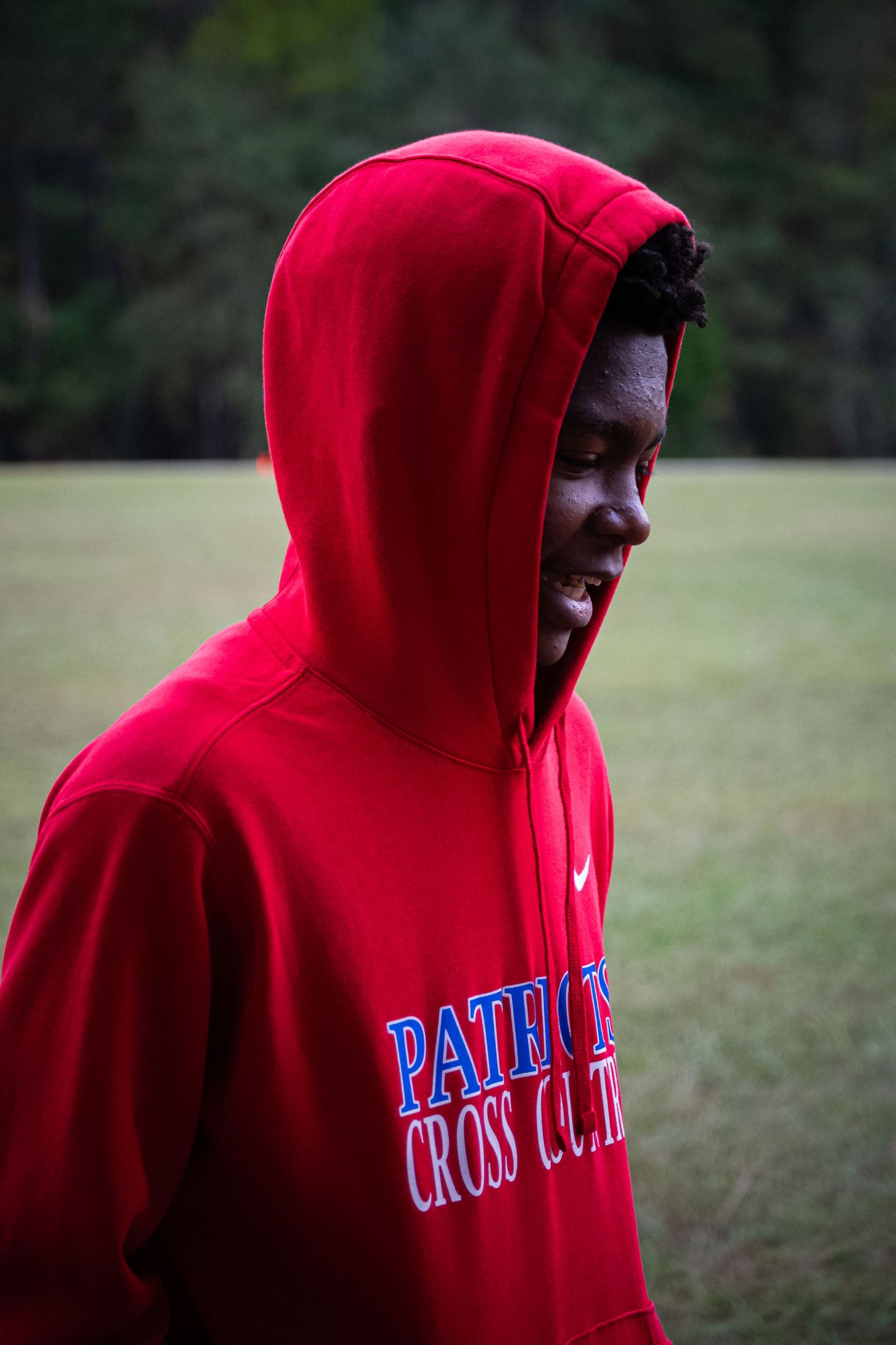 A photo of a man smiling and looking to the side