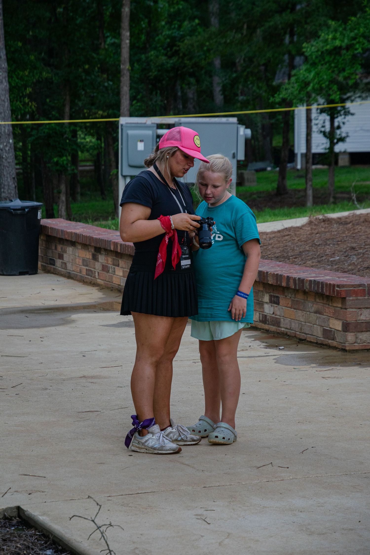 A photo of a woman showing a child her camera