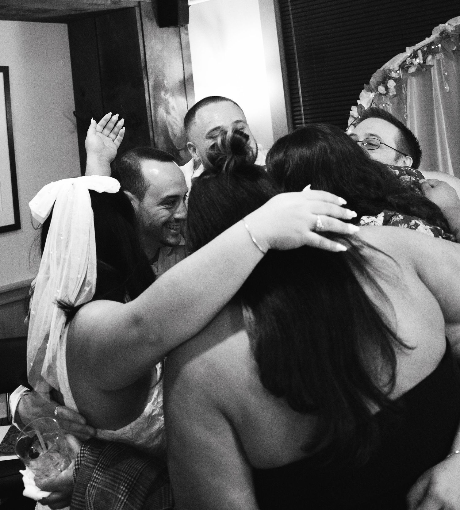 A sequence of black and white wedding photos showing emotional embraces and intimate moments during a celebration.