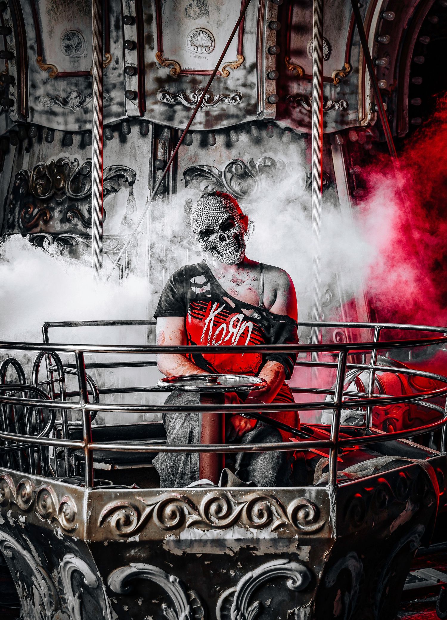 Artistic black and white urban scene with red smoke effects and decorative metal railings creating moody atmosphere.