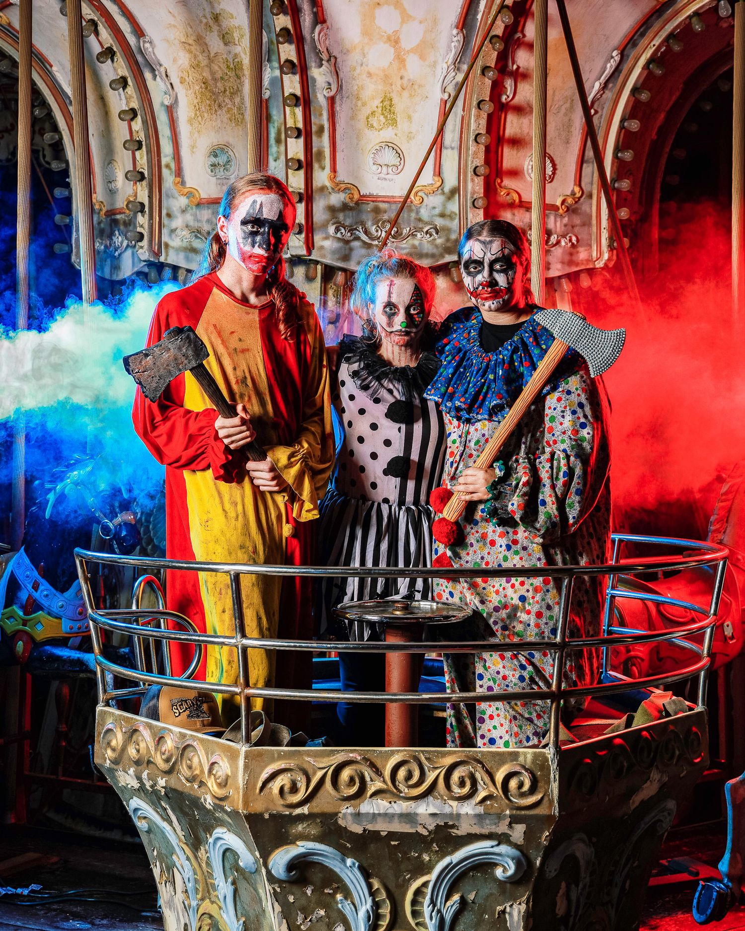 Moody carousel scene illuminated by vibrant red and blue lights creating an atmospheric carnival setting.