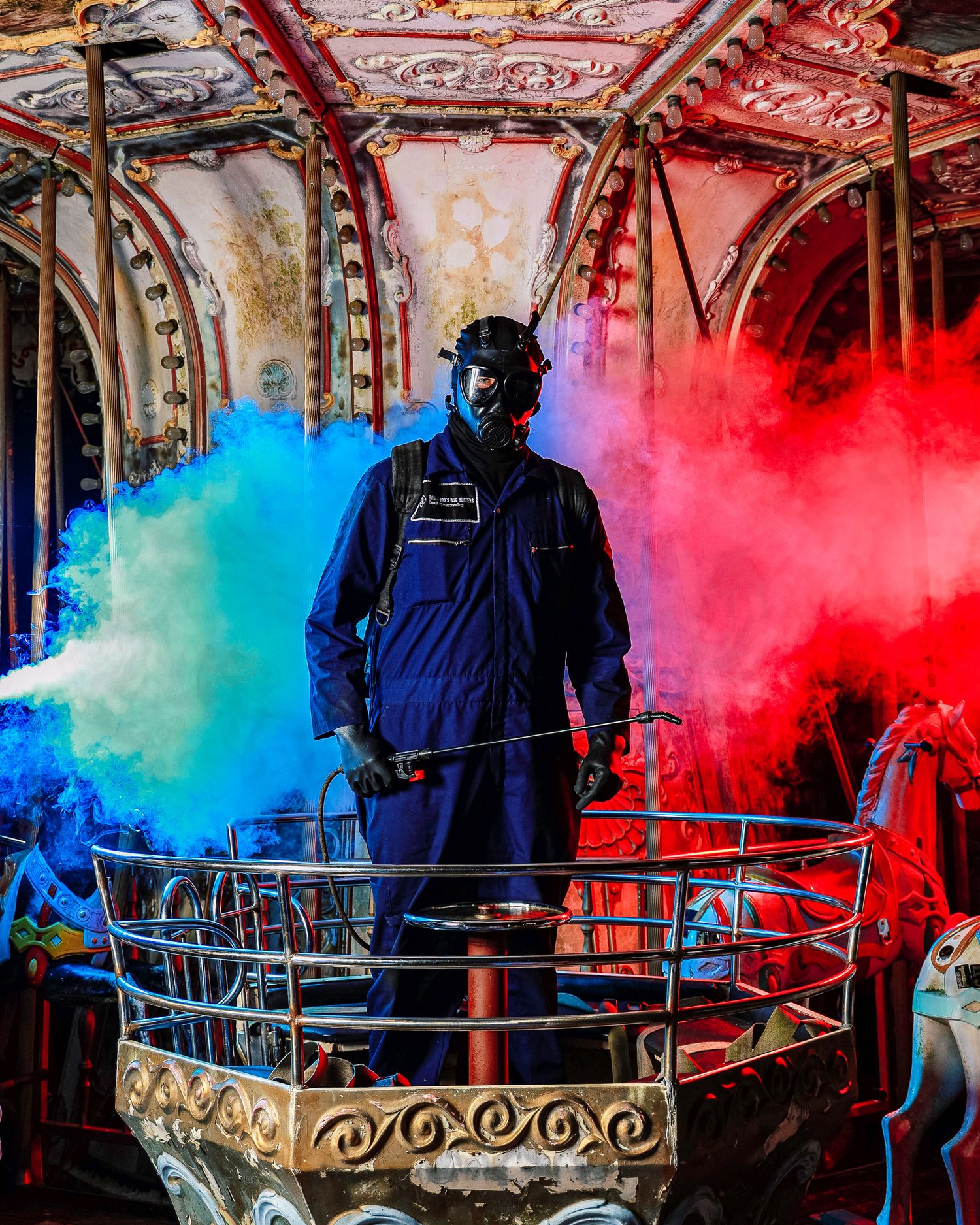 Dramatic scene with colorful smoke effects in blue and red surrounding a figure in protective gear inside an ornate structure.