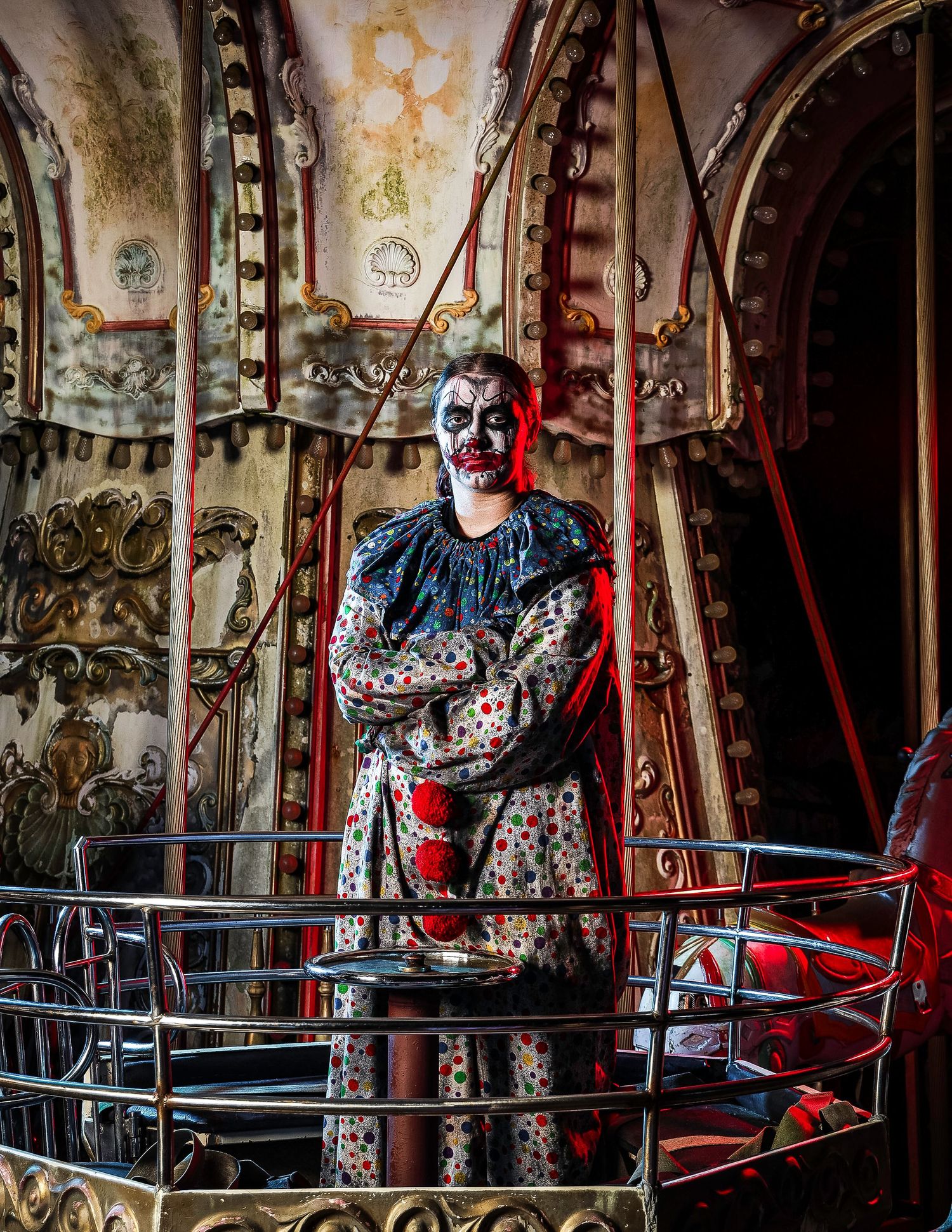 A vintage carousel with ornate decorative panels and red poles against a weathered background creates a nostalgic scene.