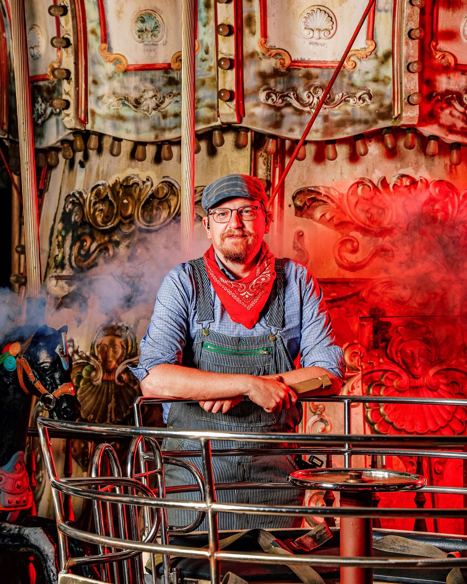 A person in a blue shirt sits at a rustic counter with red lighting and vintage decor in the background.