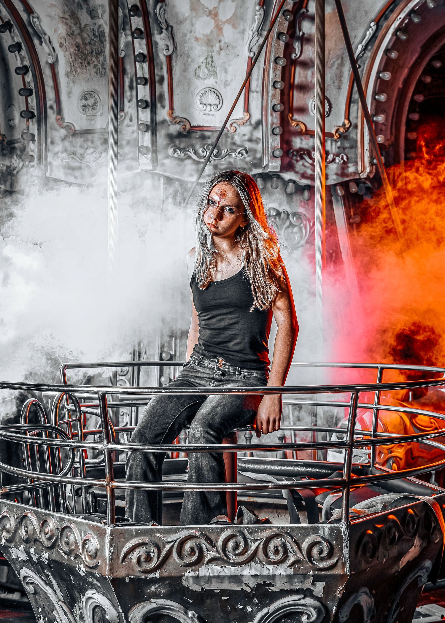 A dramatic black and white photo series with red smoke effects showing a figure posing on an ornate metal balcony.