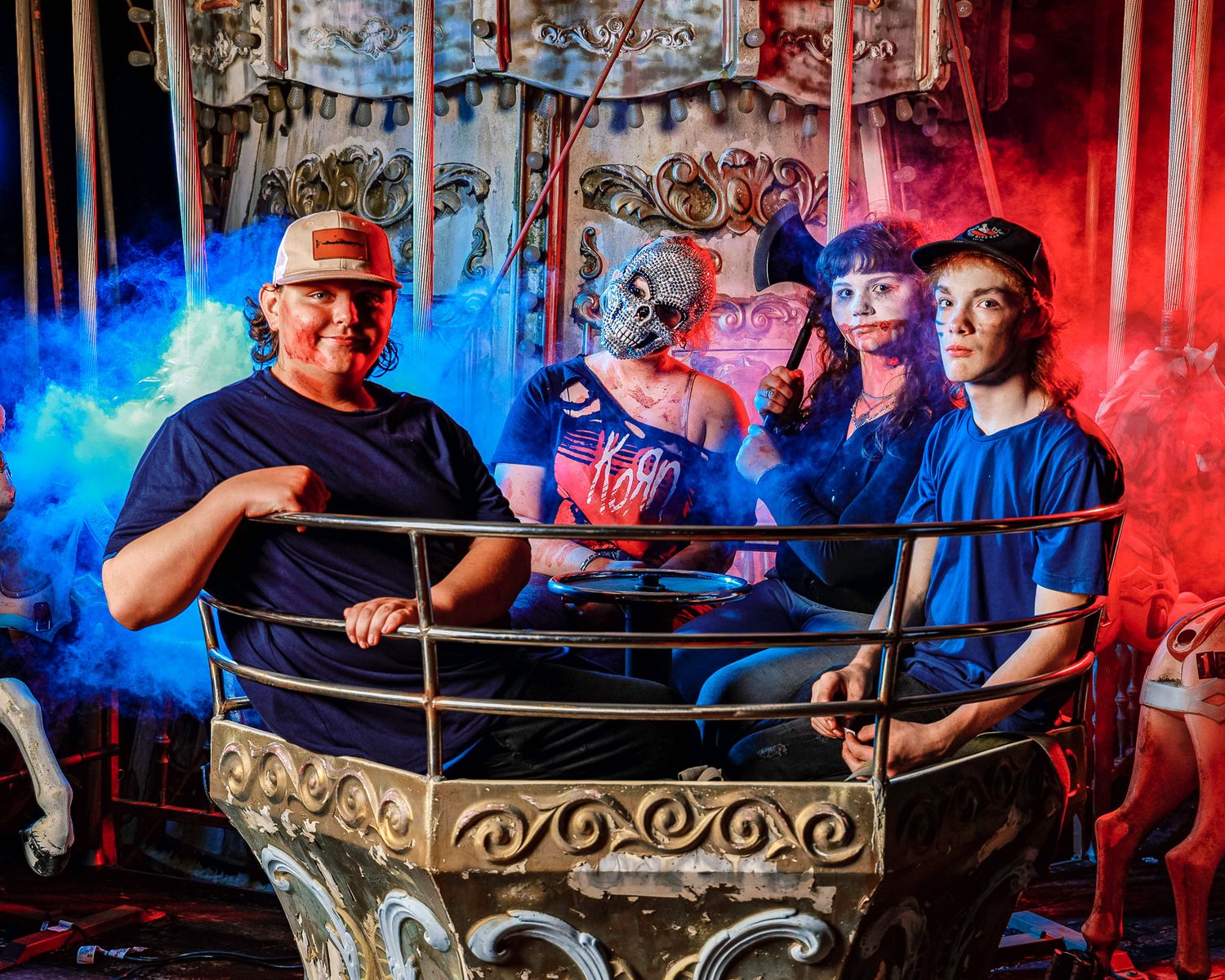 Musicians performing on stage with dramatic red and blue lighting effects.
