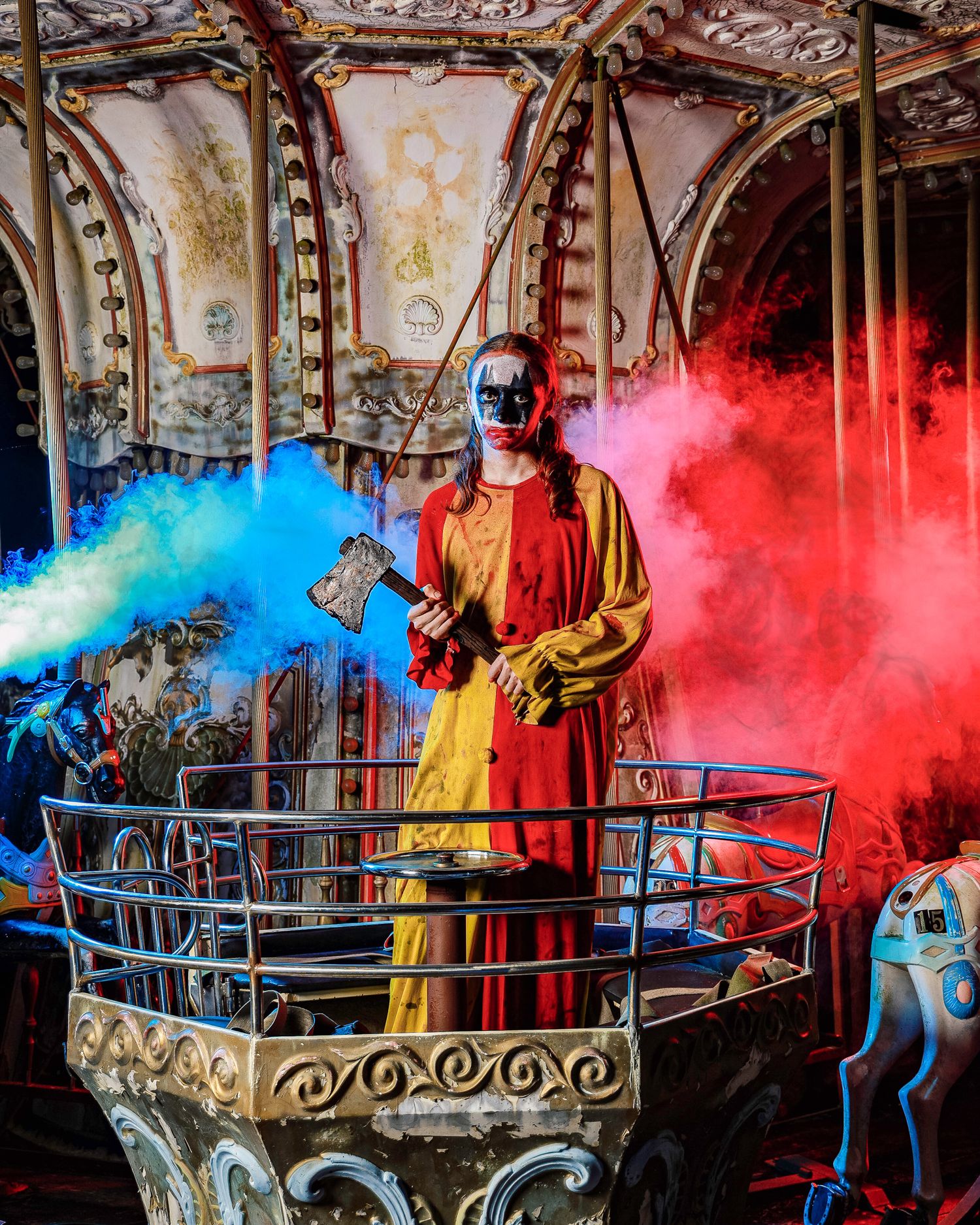 Vibrant red and blue smoke effects create a dramatic atmosphere around a decorative metal railing in an artistic display.