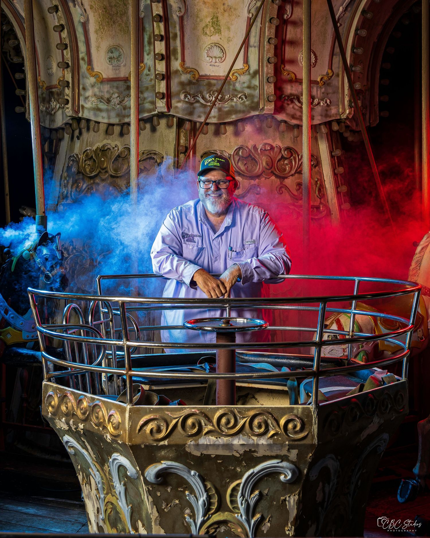 Artistic photo series showing someone at a carousel with dramatic red and blue smoke effects in low light conditions.