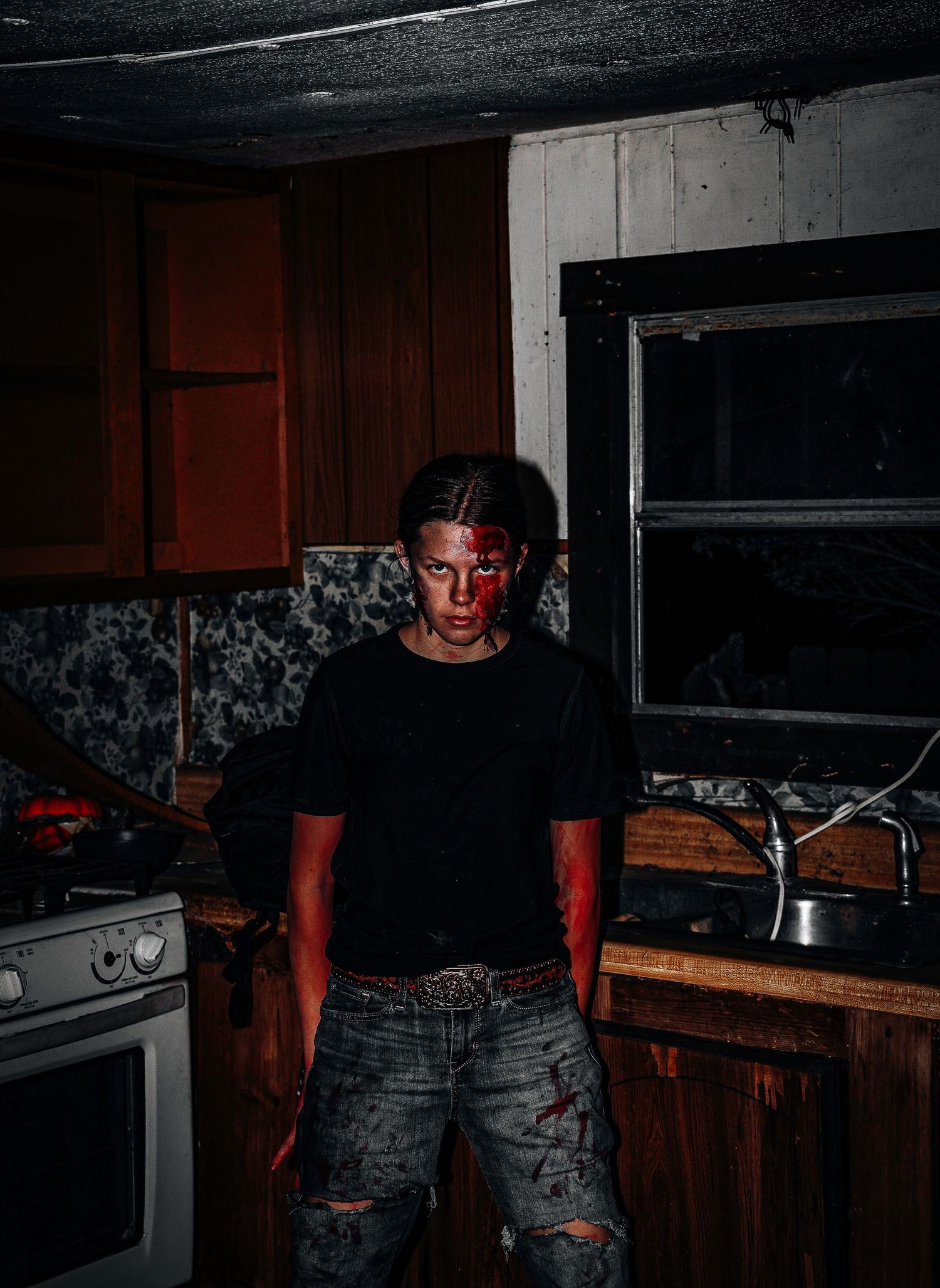 A series of dimly lit kitchen photos with red lighting creating an eerie atmosphere in a domestic setting.