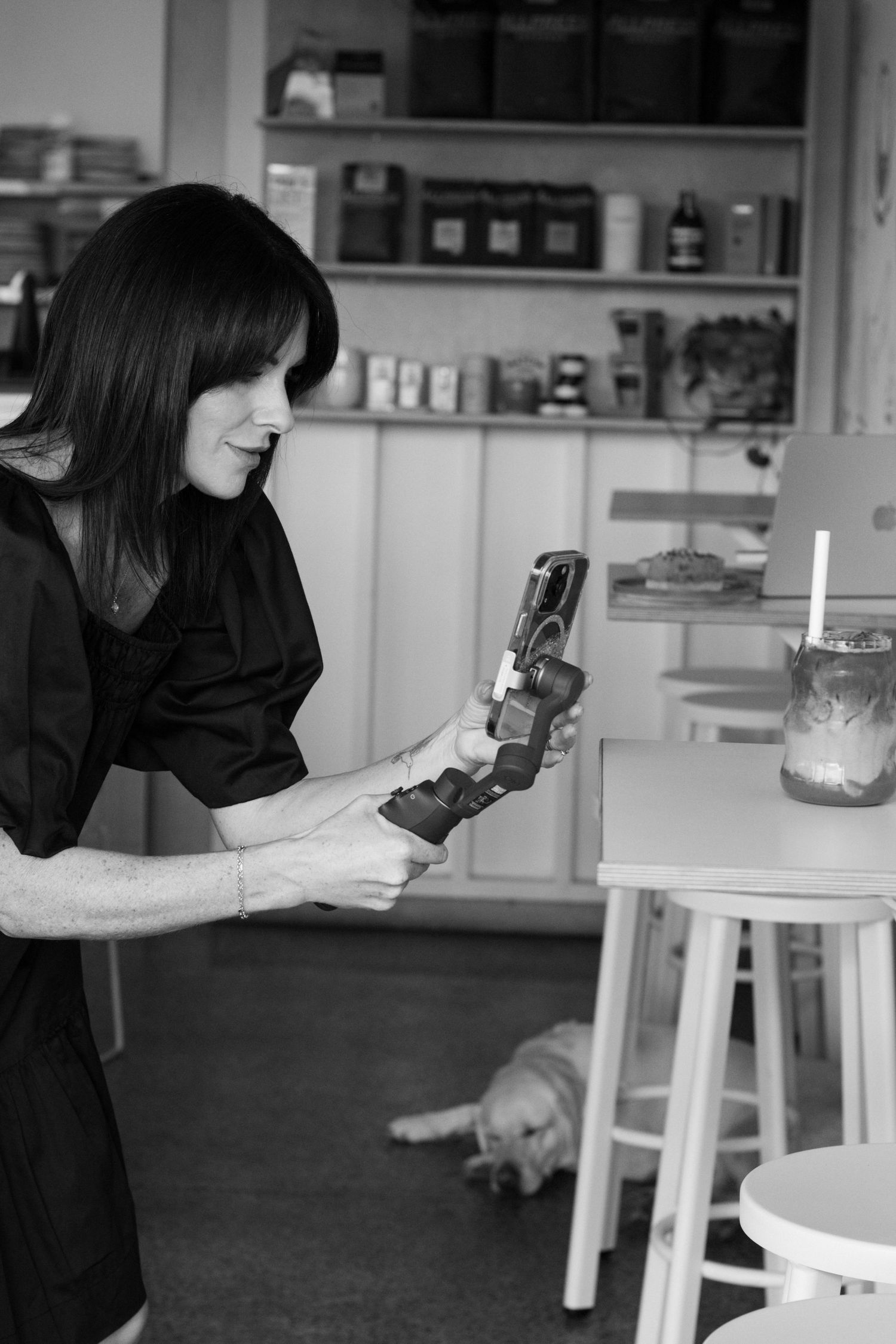 A sequence of images showing rachael ferguson content creator adjusting and videoing items on a white table in a studio setup.