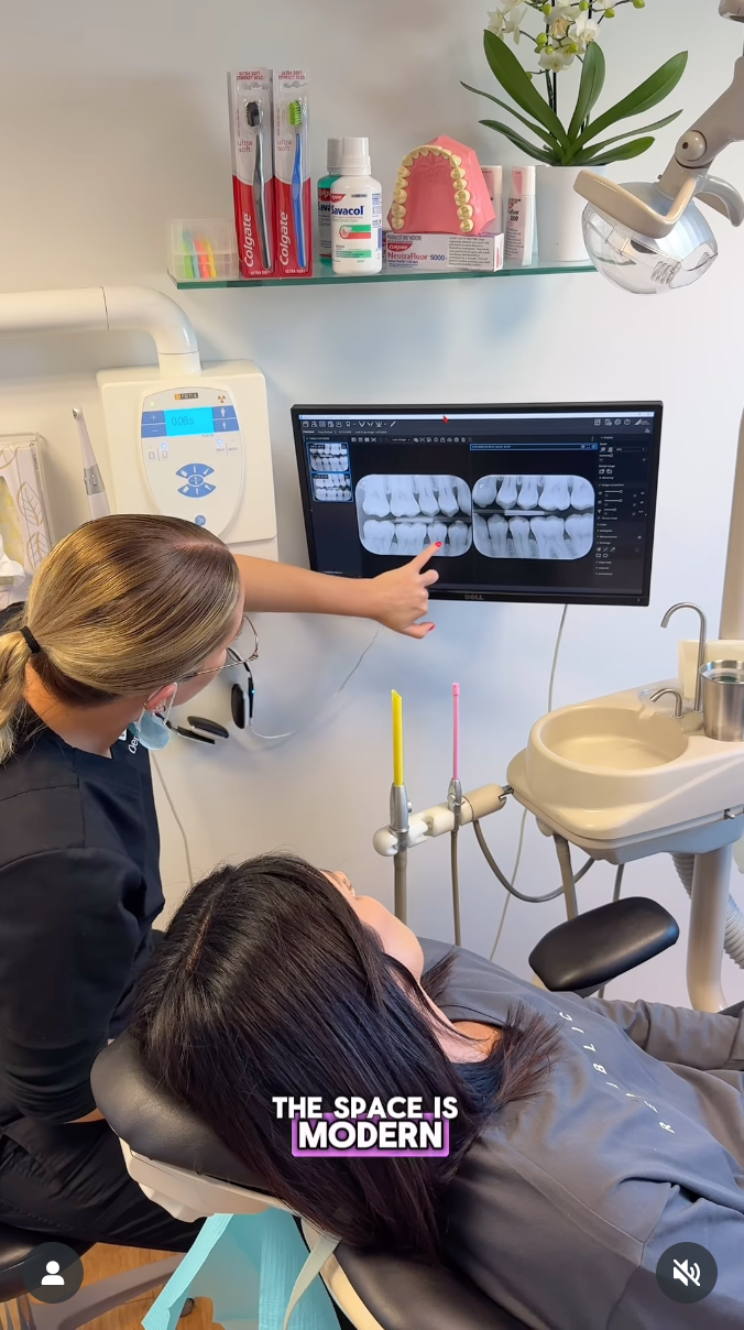 Dental plus tauranga  office showing digital x-ray display of teeth while rachael ferguson receives examination in modern treatment room.