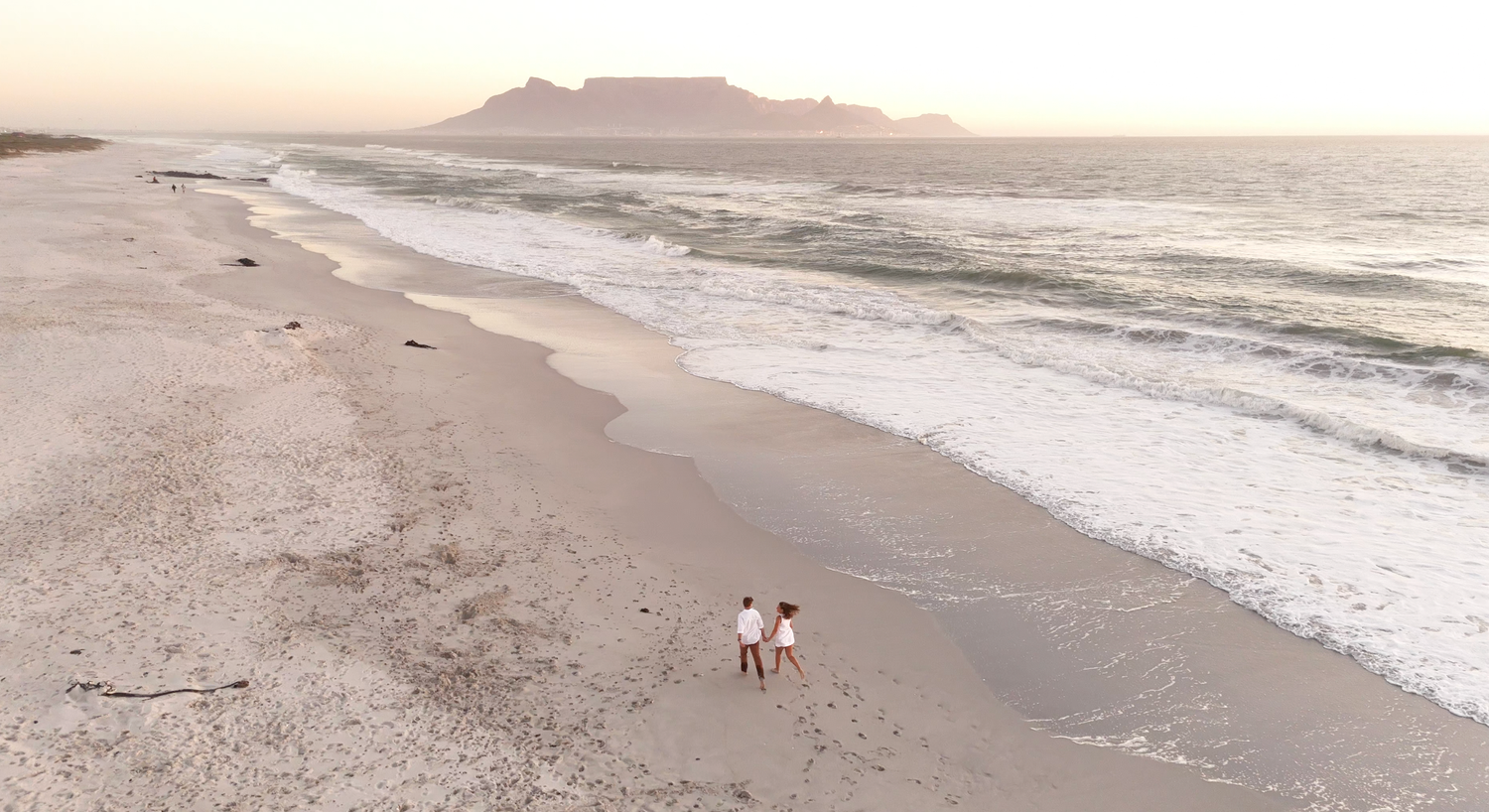 A series of aerial beach photos showing coastal landscapes with sand, water, and people enjoying the shoreline.