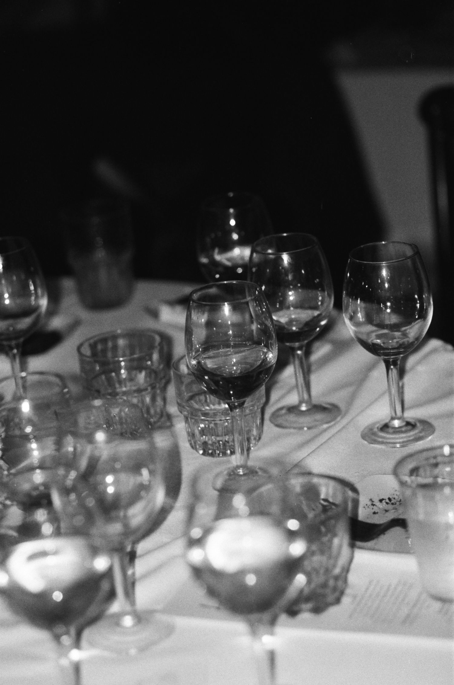 Empty wine glasses arranged on a table at a formal event.