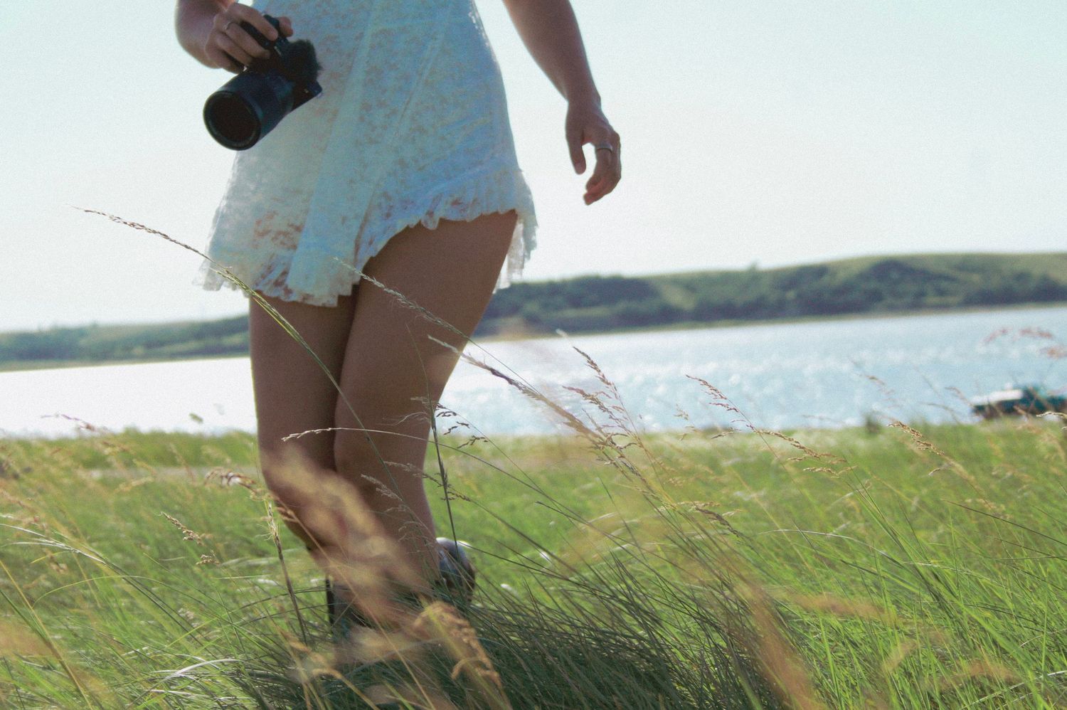 Photography equipment and gear shown in natural outdoor setting by the coast.