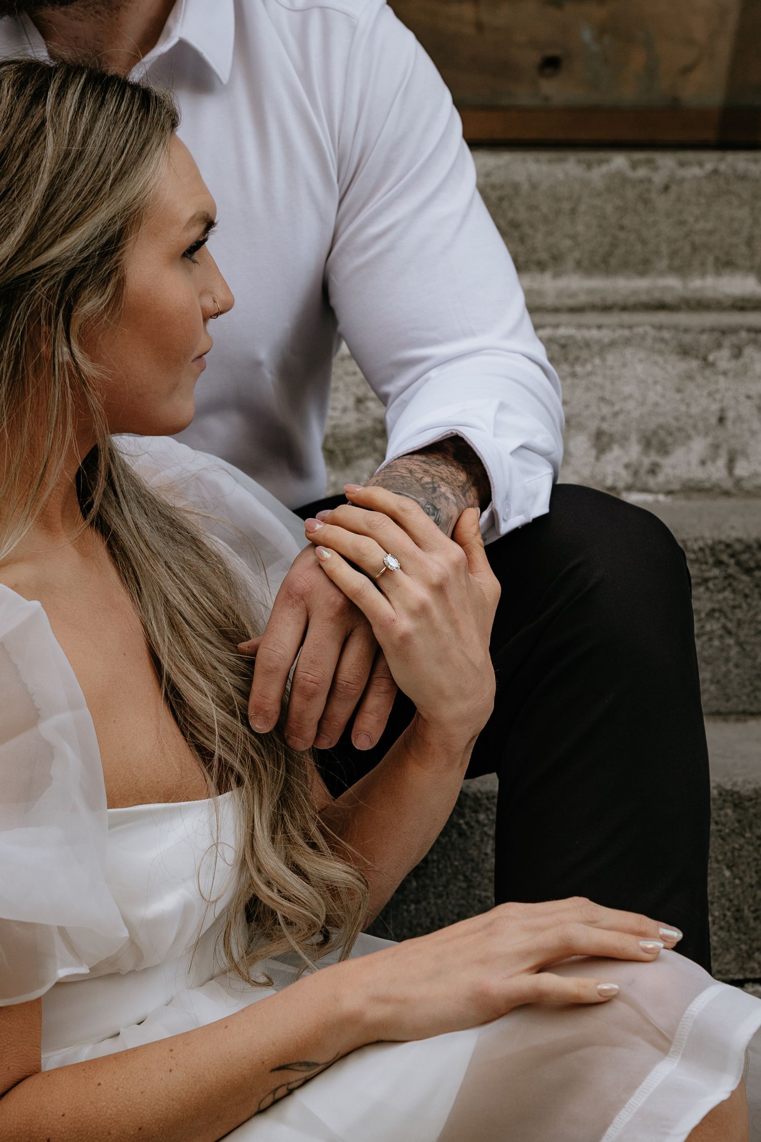 Calgary engagement photographer capturing a couple in downtown’s urban scenery with relaxed, authentic storytelling style. Stephen Ave Photo