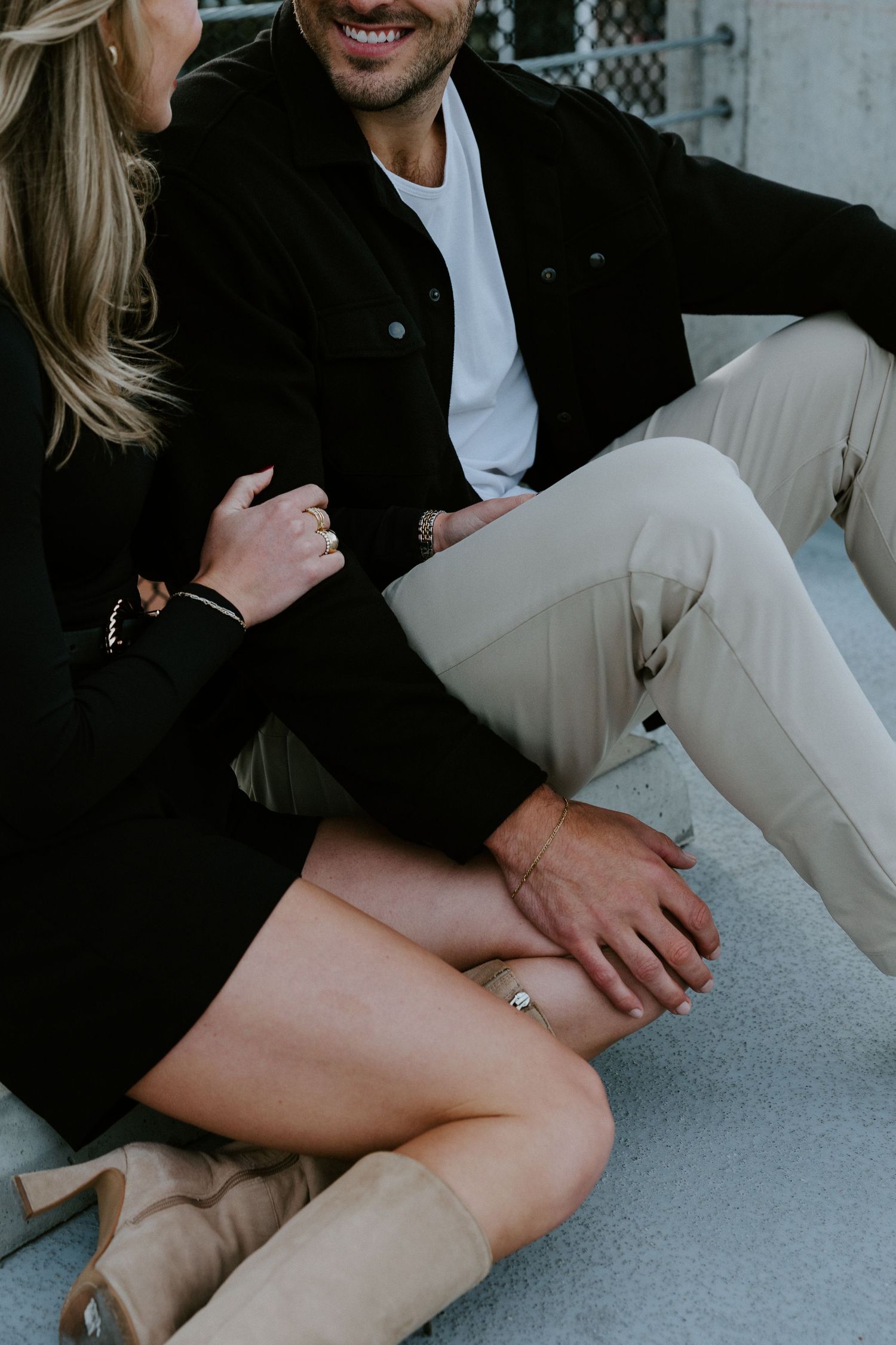 Calgary engagement photographer capturing a couple in downtown’s urban scenery with relaxed, authentic storytelling style