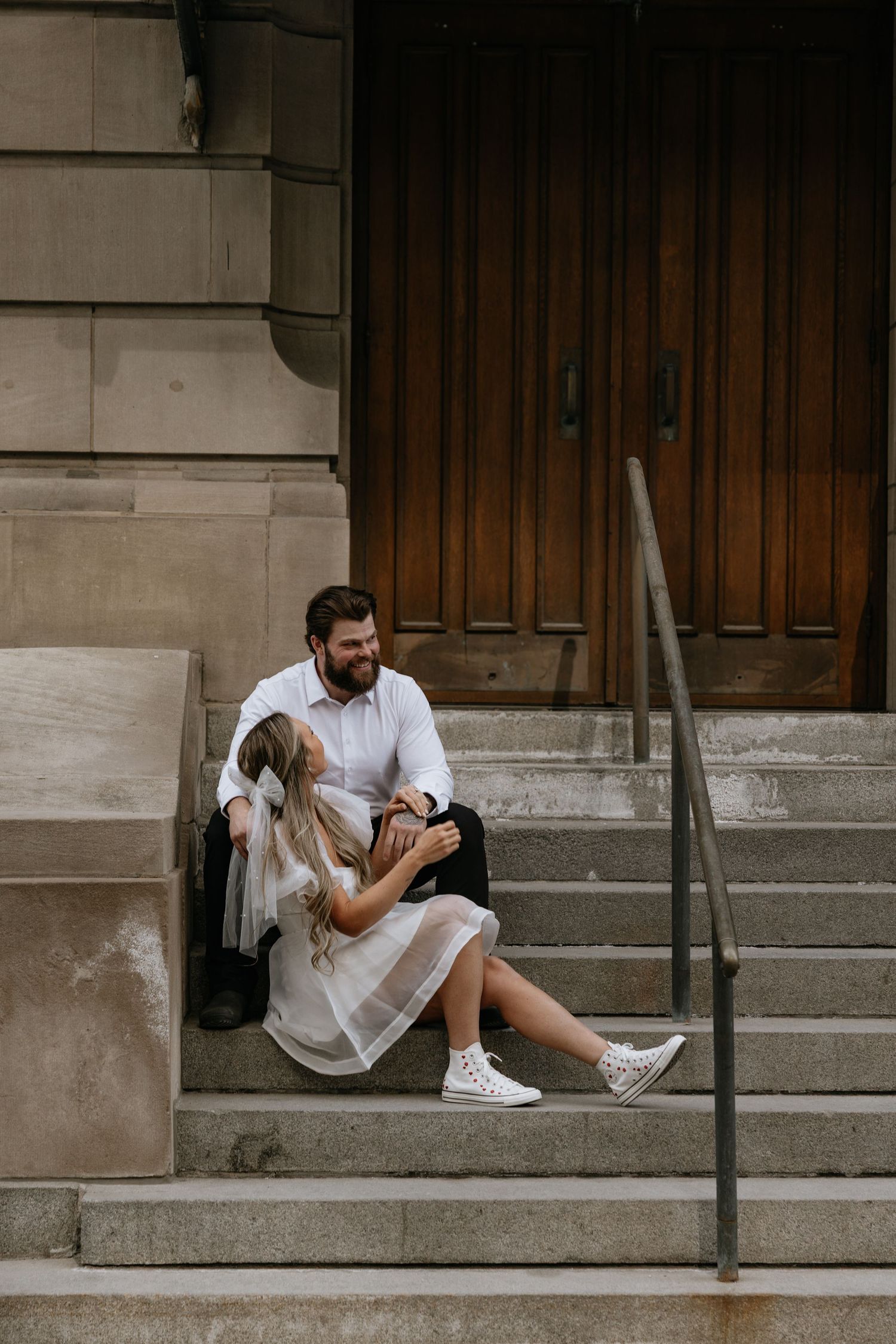 Calgary engagement photographer capturing a couple in downtown’s urban scenery with relaxed, authentic storytelling style. Stephen Ave Photo