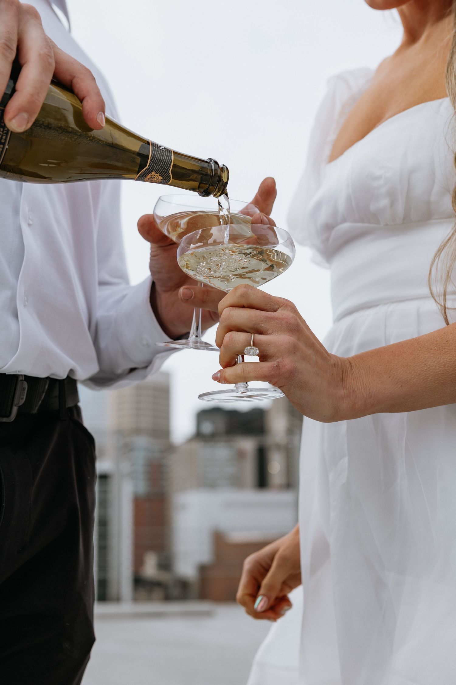 Calgary engagement photographer capturing a couple in downtown’s urban scenery with relaxed, authentic storytelling style
