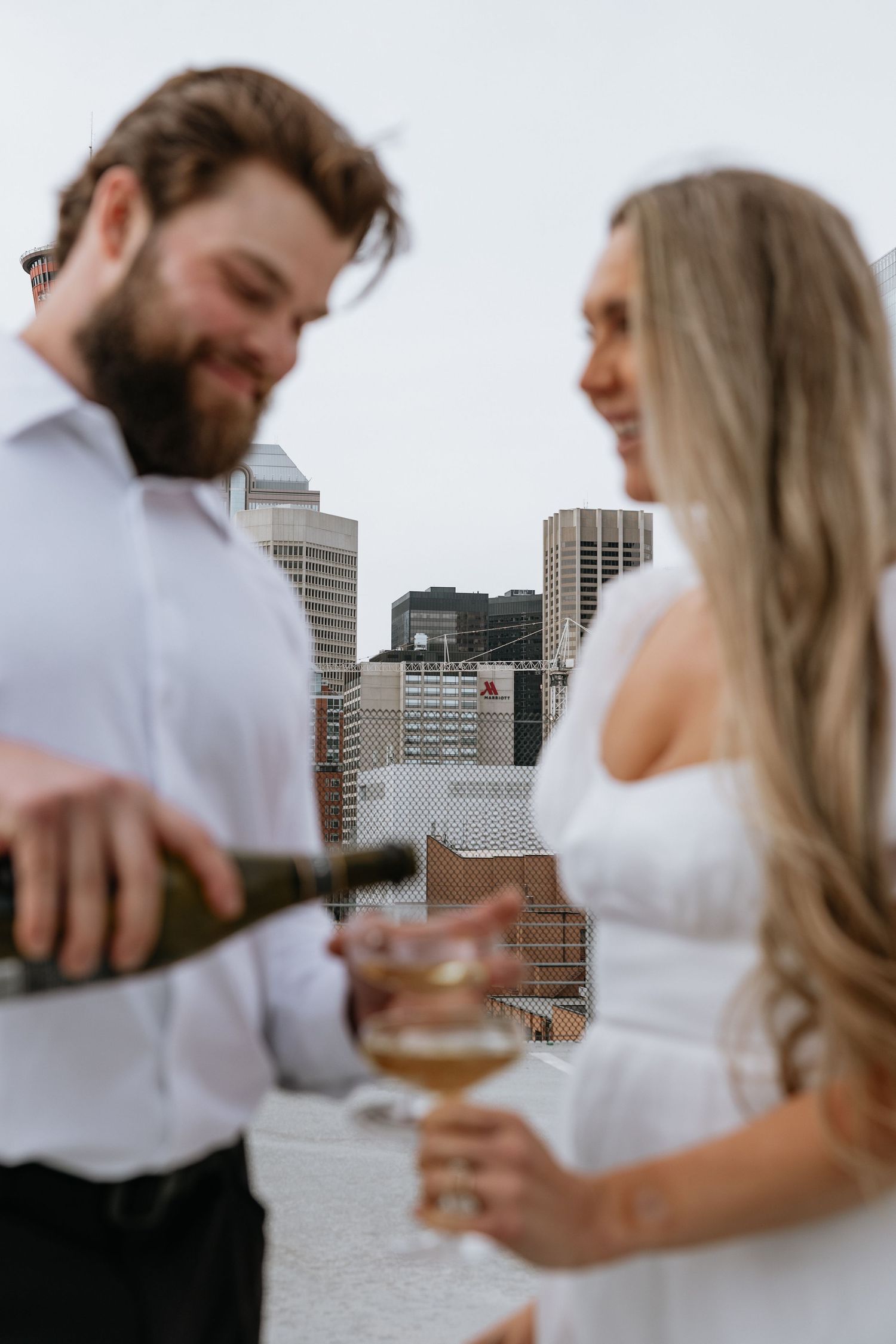 Calgary engagement photographer capturing a couple in downtown’s urban scenery with relaxed, authentic storytelling style. Stephen Ave Photo