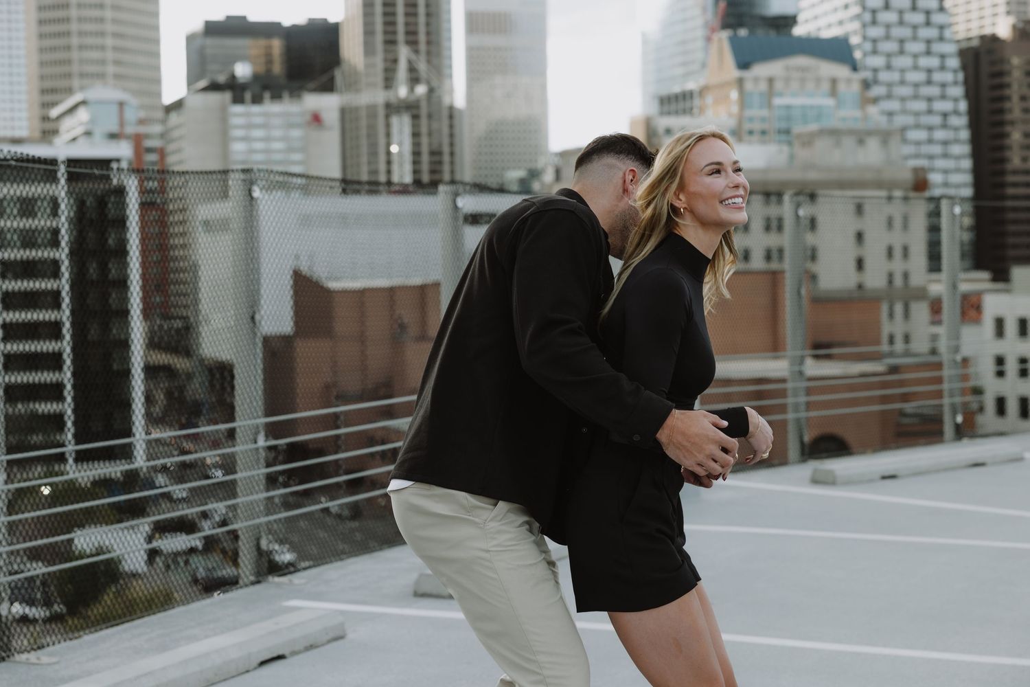 Calgary engagement photographer capturing a couple in downtown’s urban scenery with relaxed, authentic storytelling style. Stephen Ave Photo
