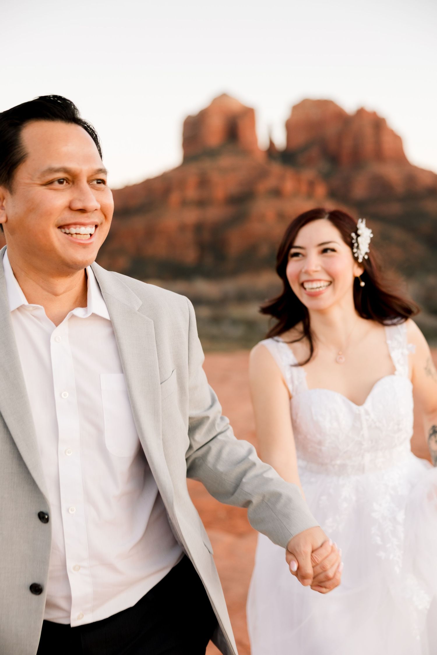 Sharing a moment of joy after their vow renewal at the Red Rock Mountains in Sedona Arizona. Phoenix wedding photographer. Arizona wedding.