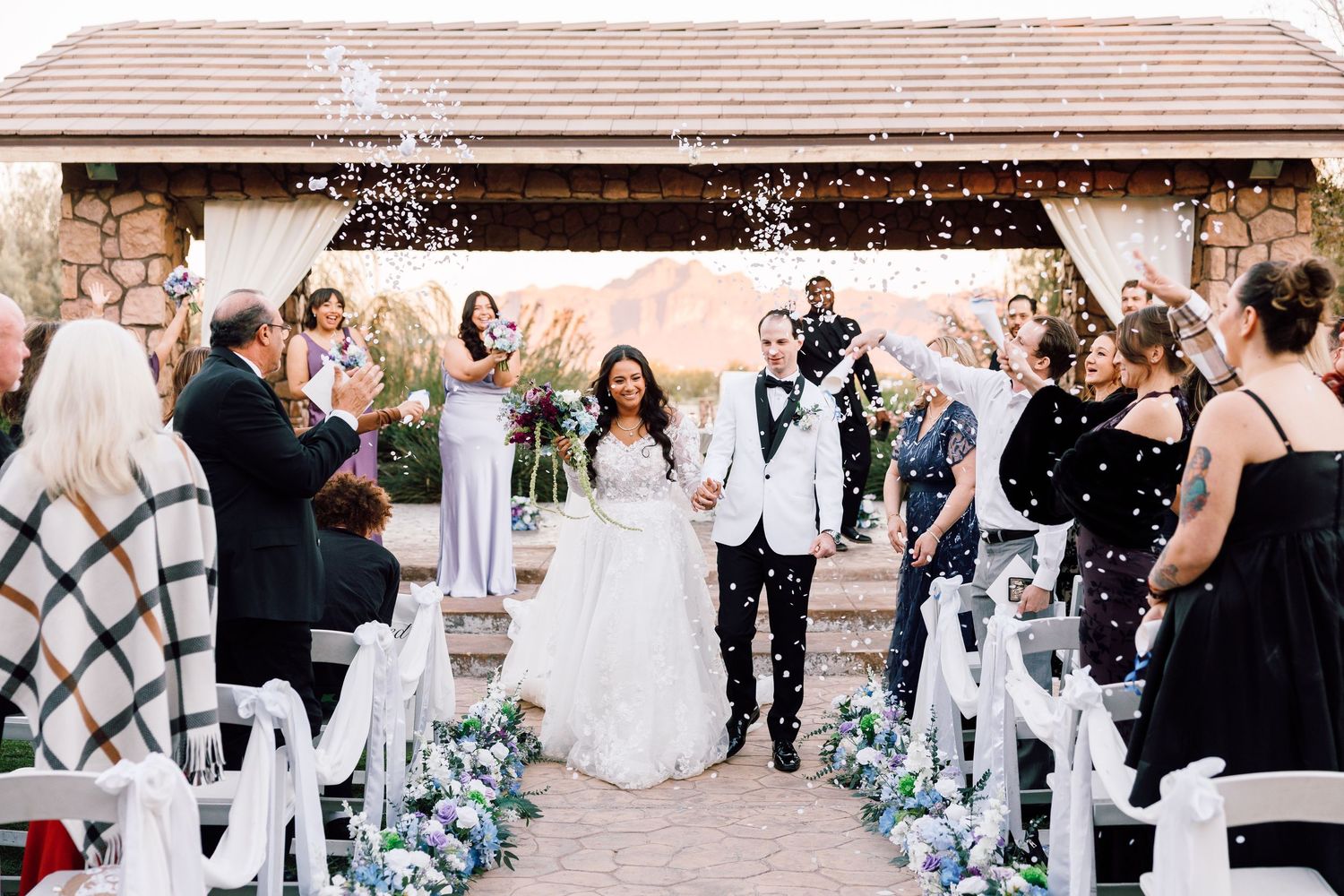 Bride and groom walks back down the aisle as husband and wife at Superstition Manor in Arizona. Scottsdale wedding photographer.