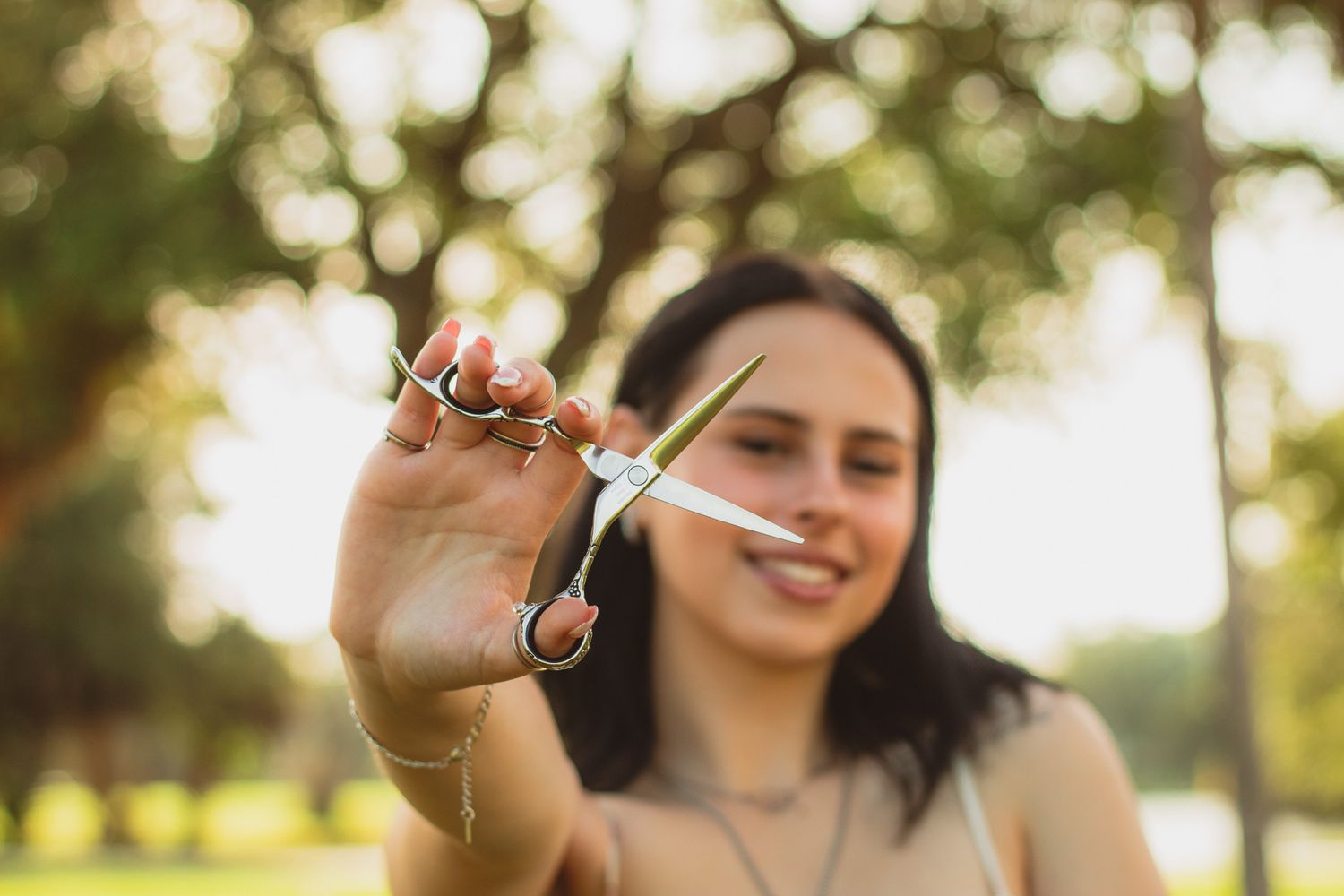 portrait of a young woman holding out her scissors