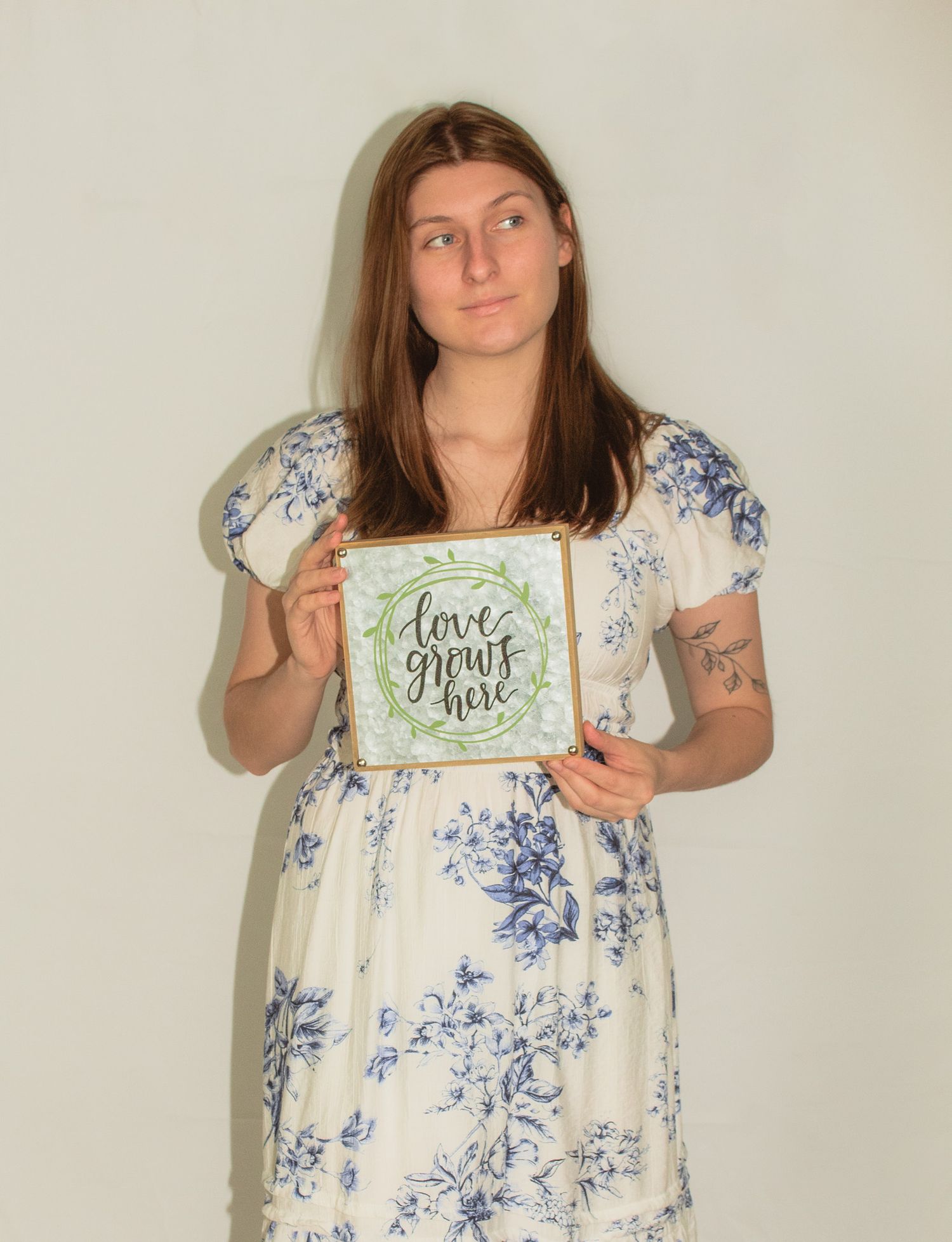 a portrait of Sarah Beth holding a sign that says 