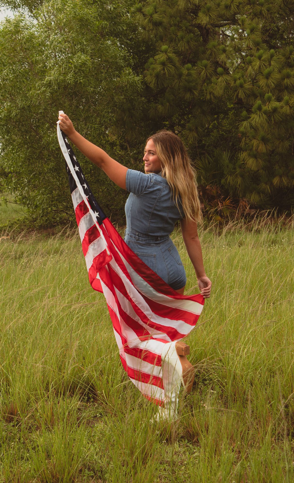 a portrait of a woman holding up a flag