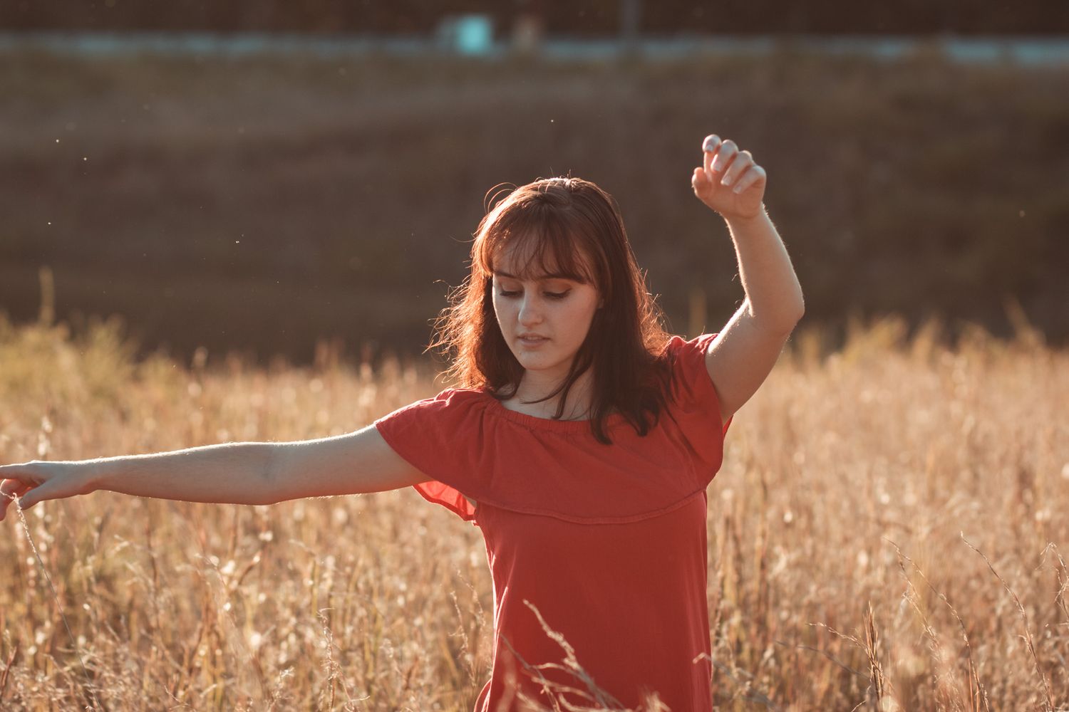 a portrait of a woman dancing in a field