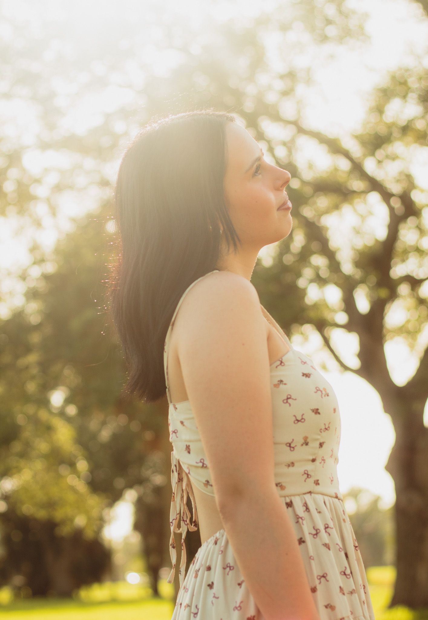 portrait of a young woman backlit by the rising sun