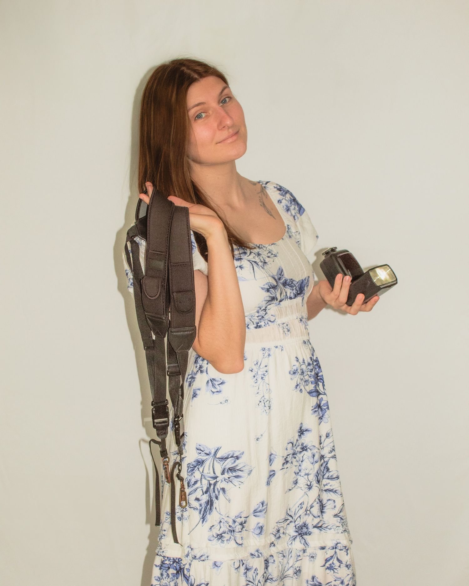 a portrait of Sarah Beth holding her gear