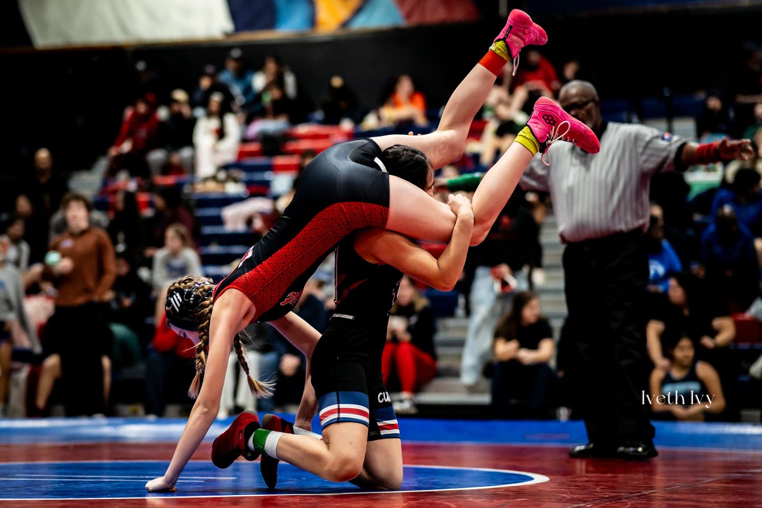 Multiple action shots of wrestlers competing in matches on blue wrestling mats.