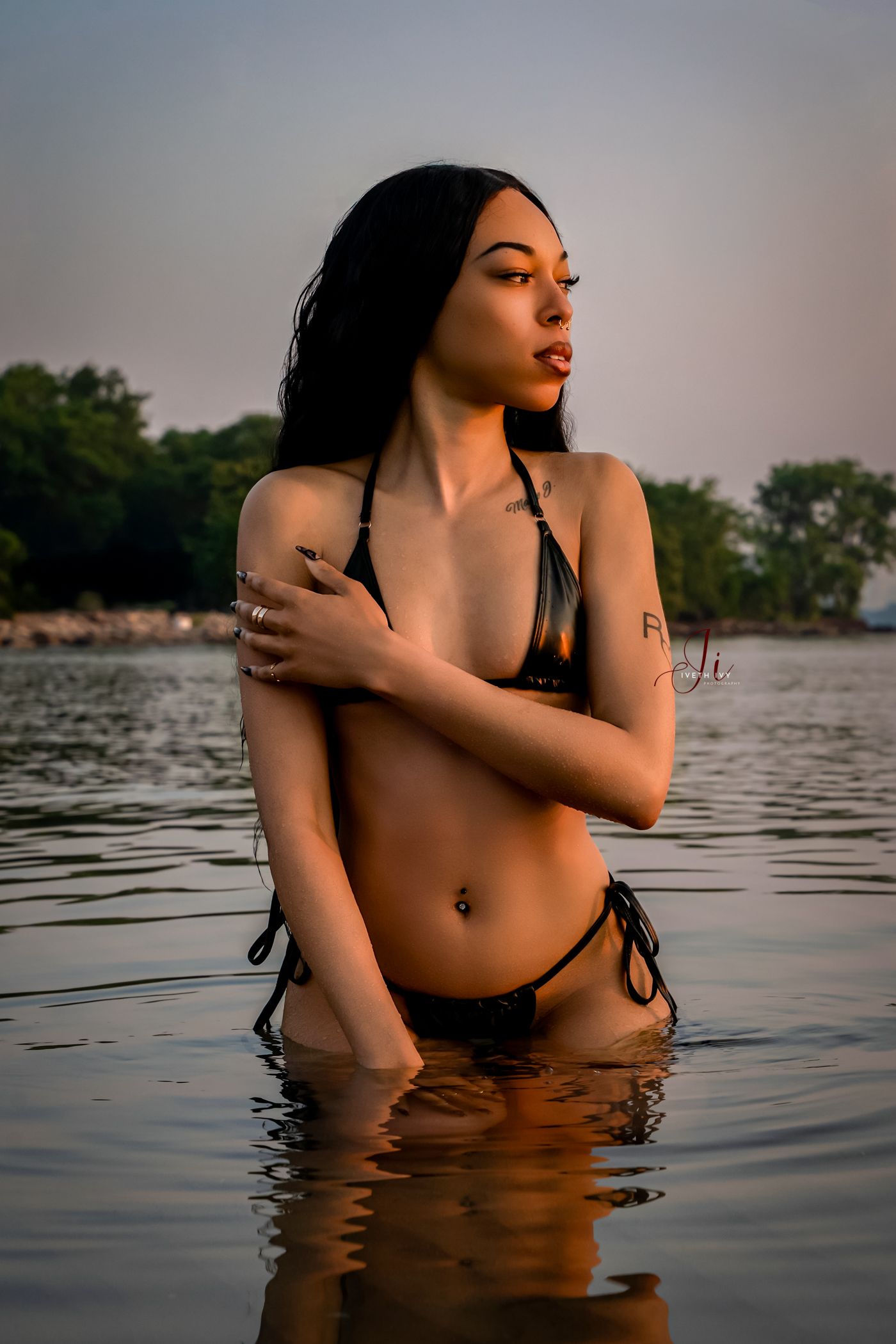 Artistic boudoir photography series showing woman in dark water during sunset.