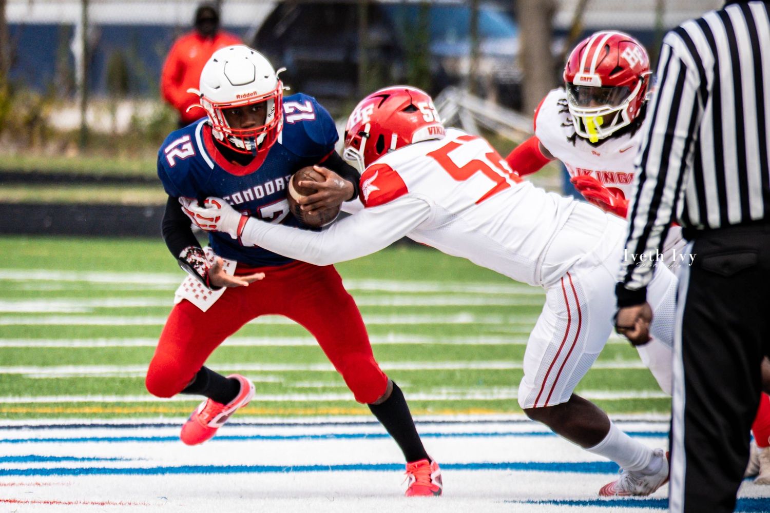 Football players diving and reaching for the ball during an intense goal-line play.