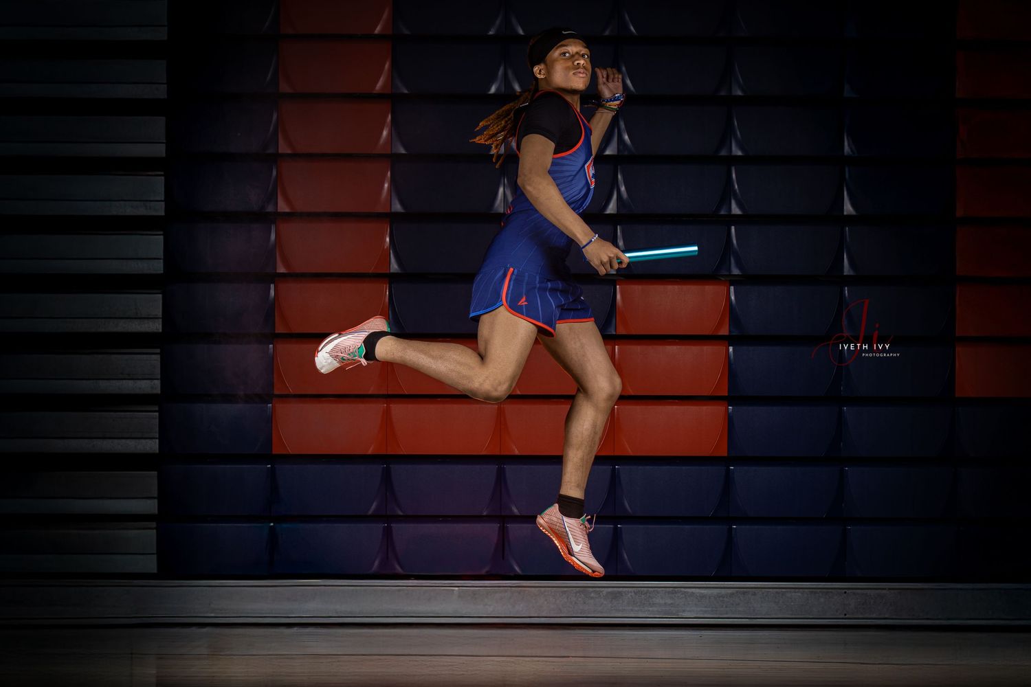 A gymnast performs a series of acrobatic leaps in sequence across multiple frames wearing blue leotard.