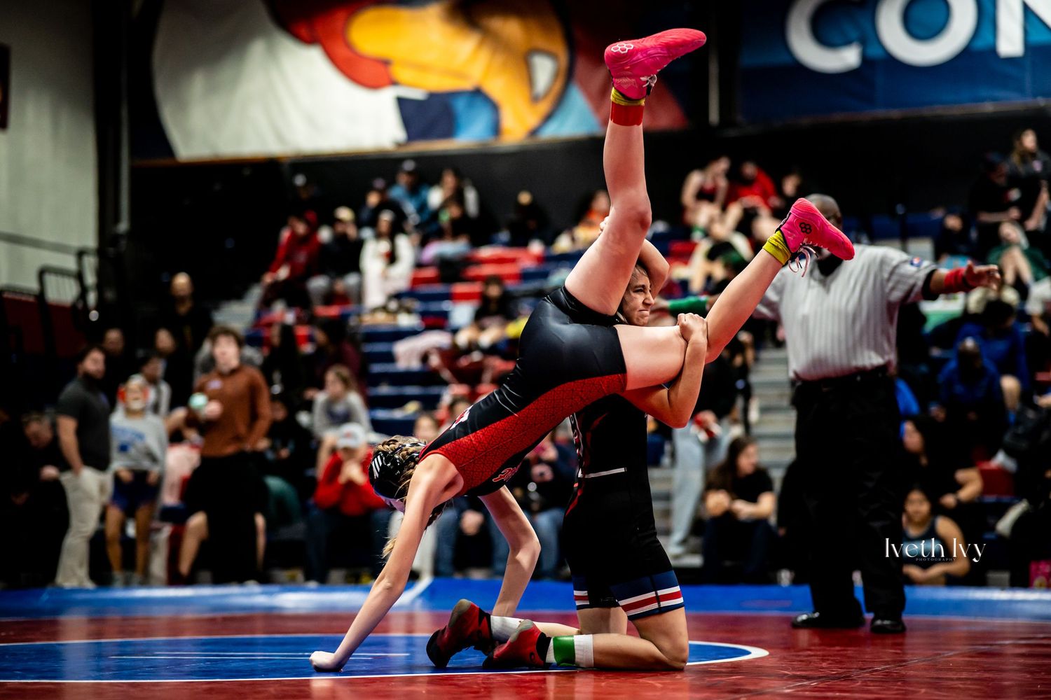 A sequence of wrestling moves shown in action during a competitive match on a red mat.
