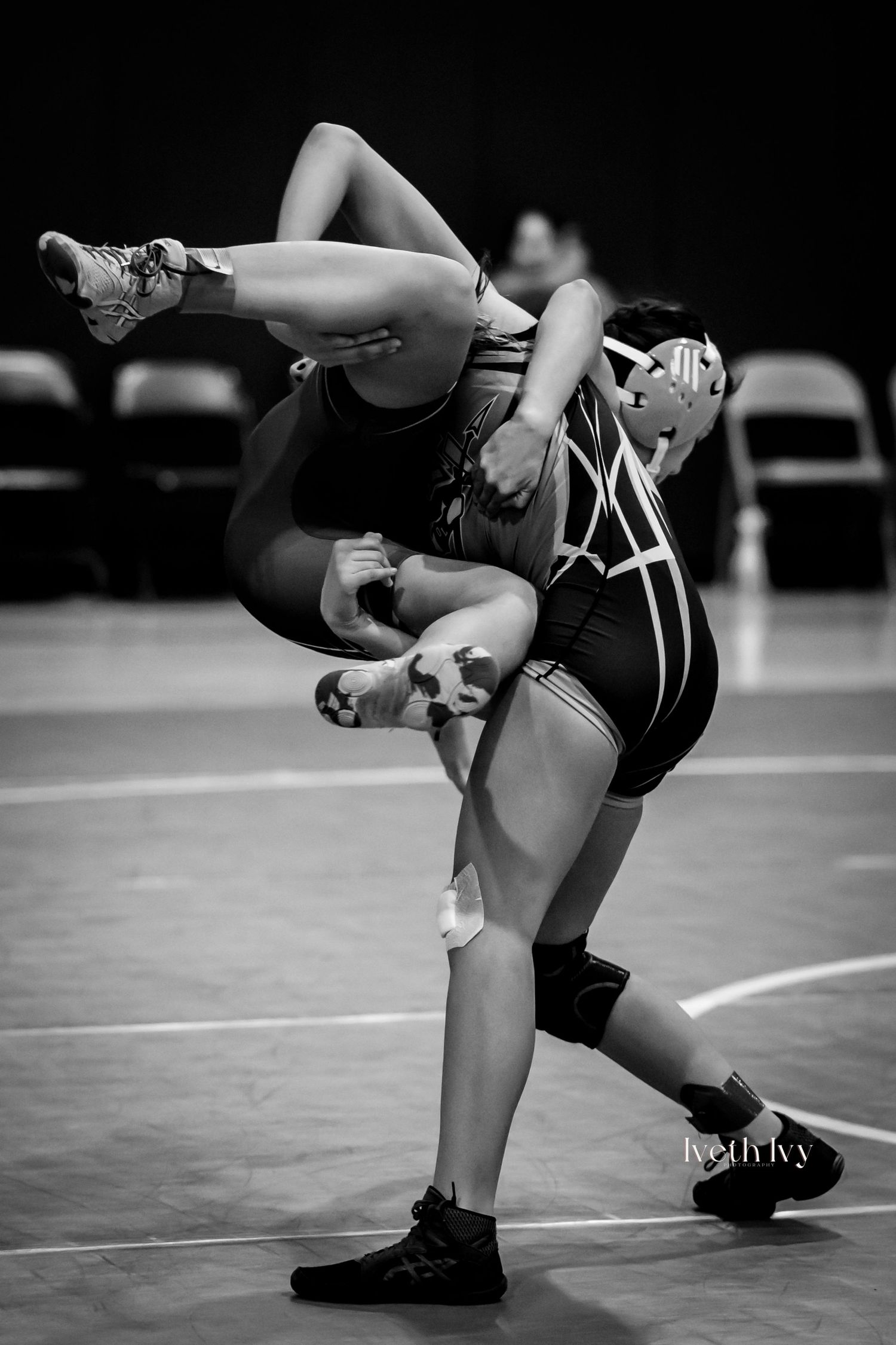 Black and white photo sequence showing close-up of wrestling moves and leg positions on a mat during competition.