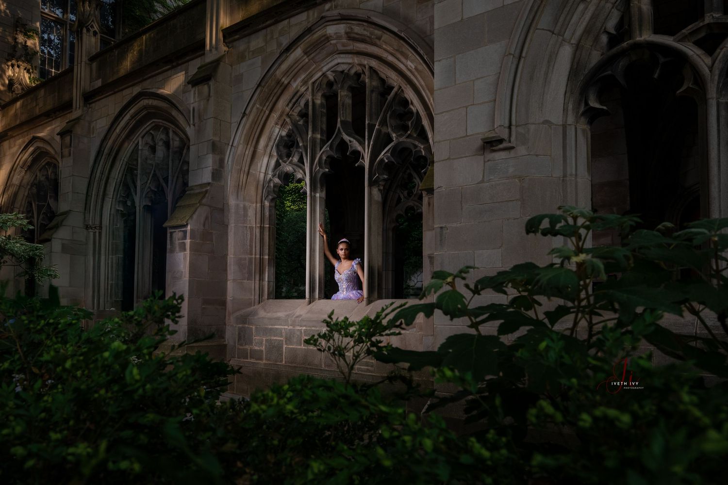Gothic arched windows and stone facades create a dramatic architectural composition in evening light.