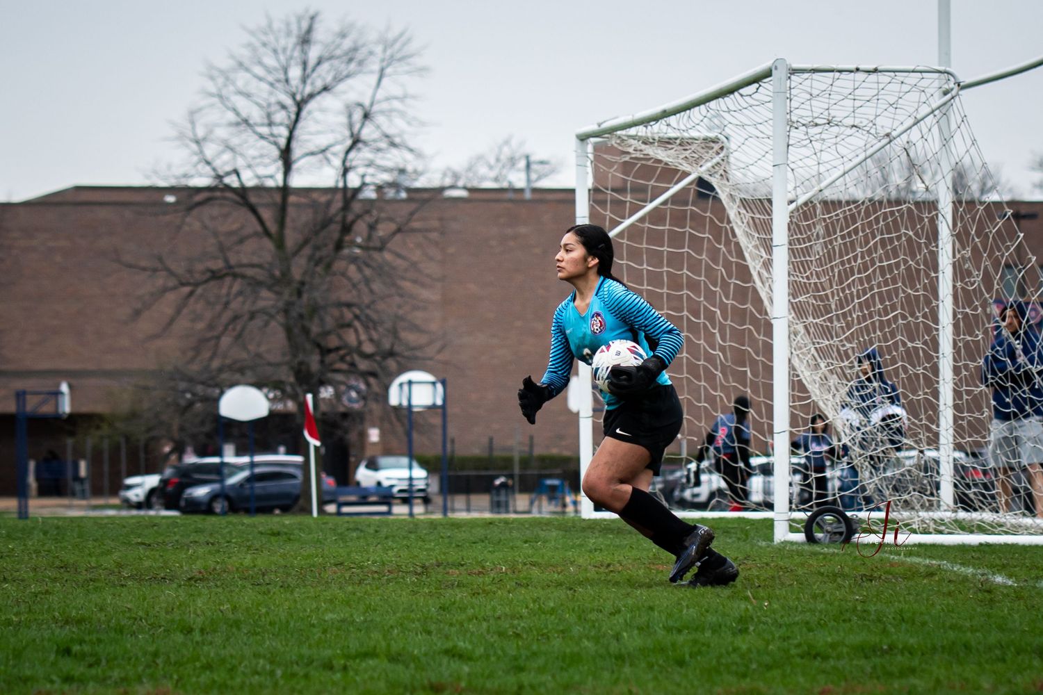 A sequence of images shows a diving soccer goalie making a dramatic save at the goal during a match.