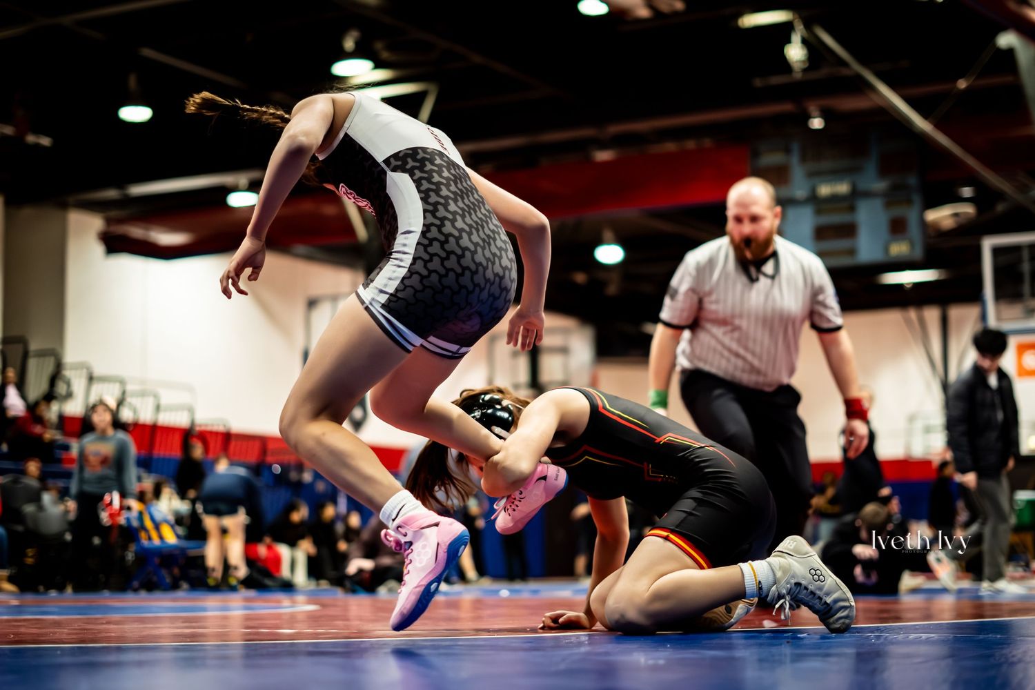 Dynamic sequence of wrestling moves showing athletes grappling and competing on red and blue mats during a match.
