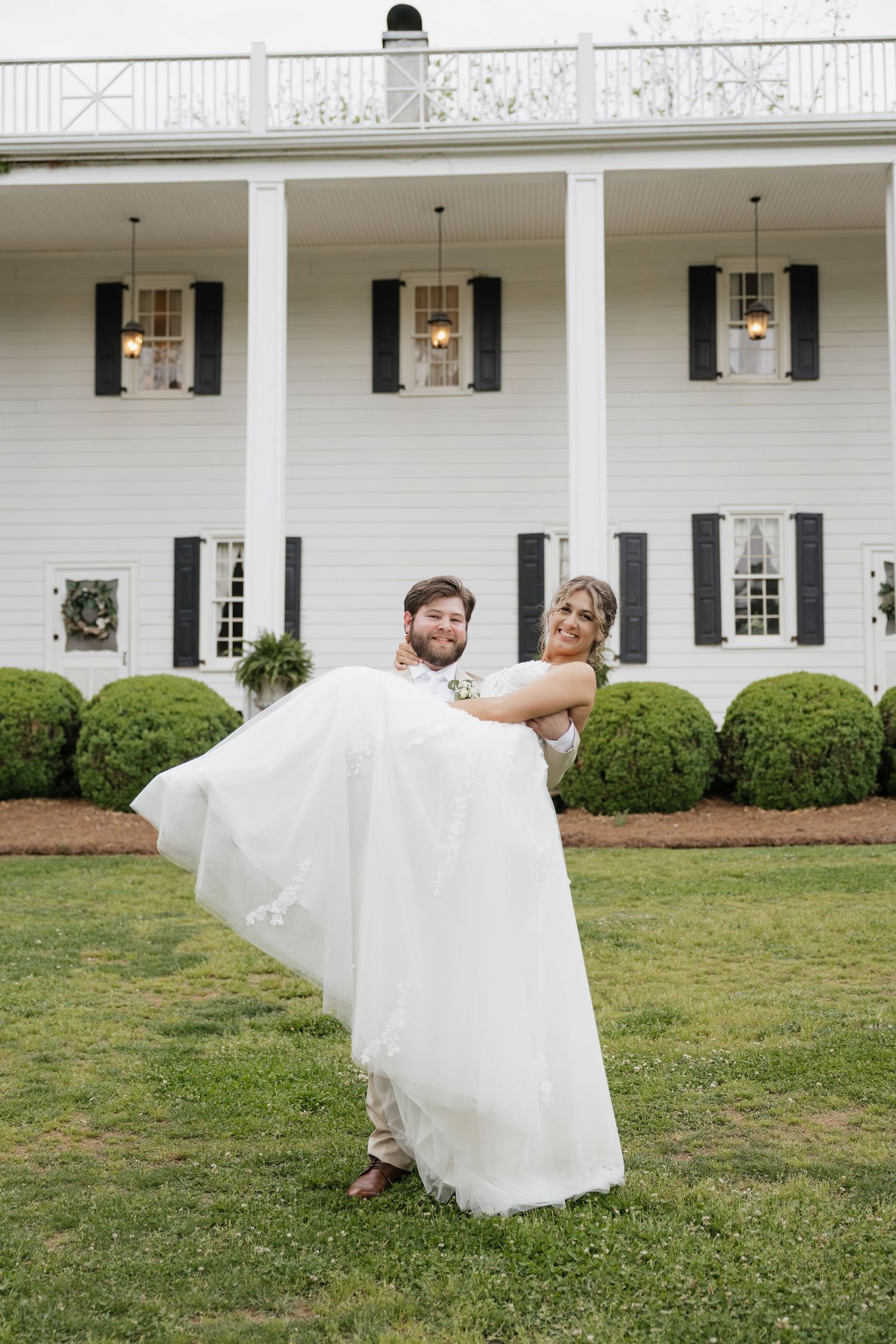 groom carrying bride at North Carolina wedding venue