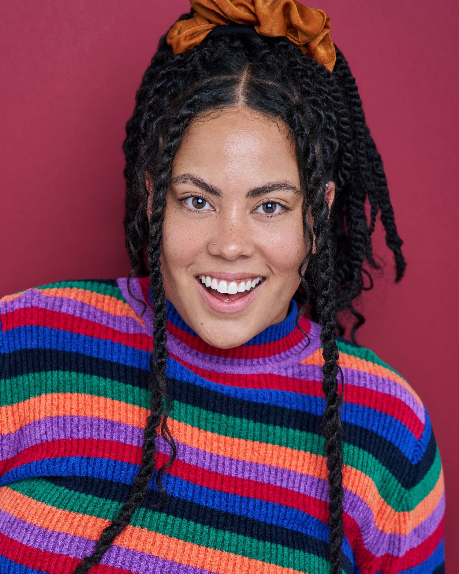Fashion portraits in vibrant multicolored striped turtleneck sweater.