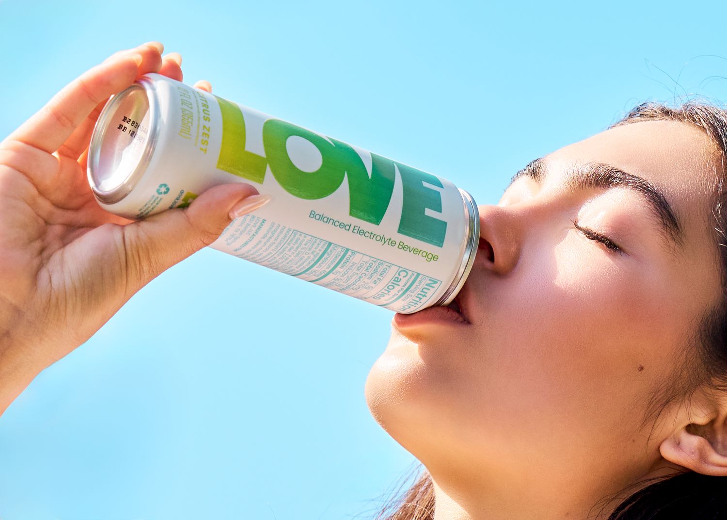 Refreshing beverage cans against bright blue sky background in a dynamic sequence.