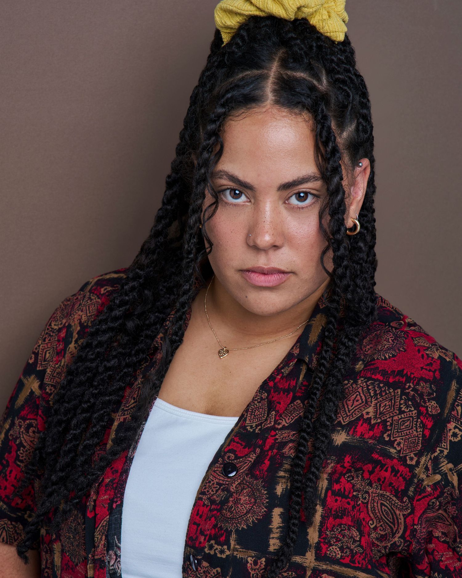 Fashion portraits featuring patterned jacket and white top against neutral background.