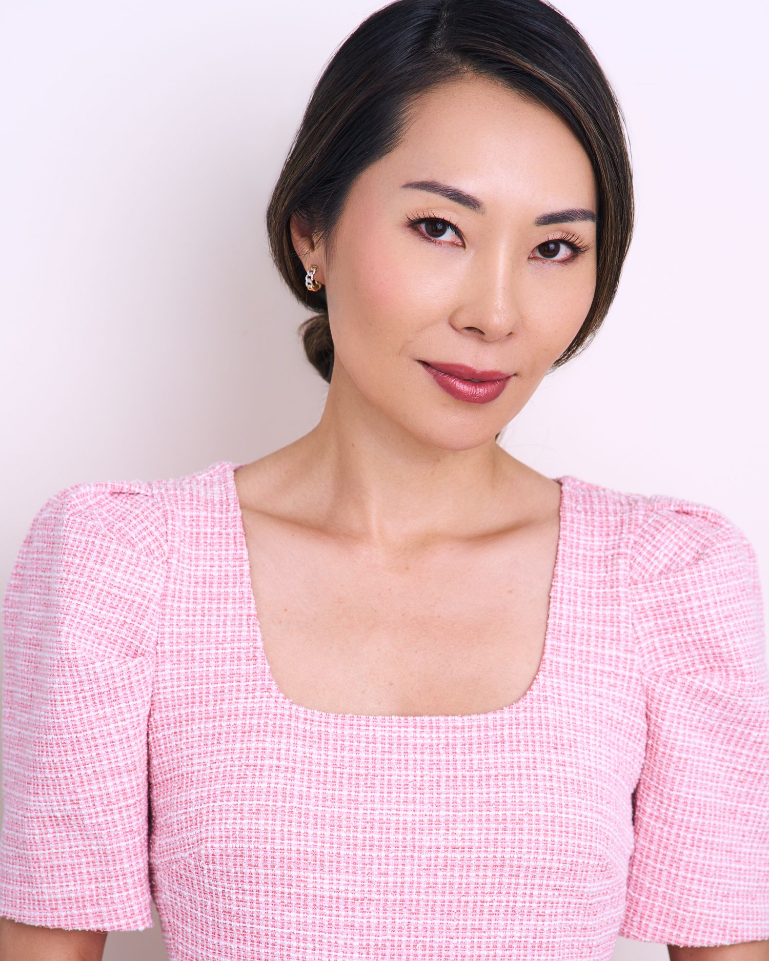 Portrait series in pink textured top showing confident expressions against white background.