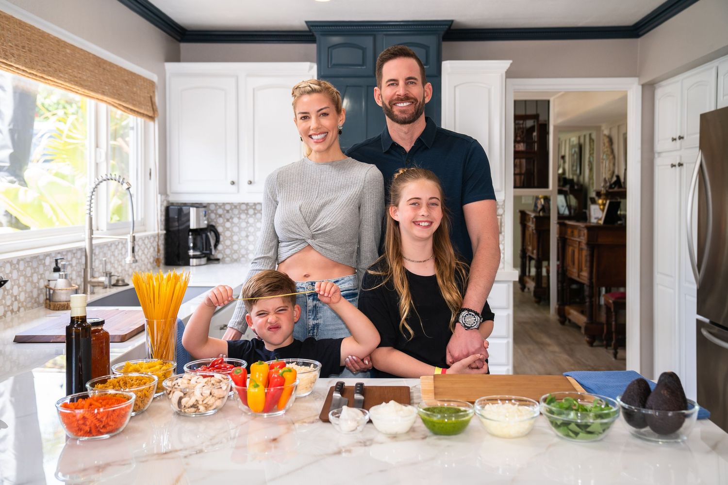 Tarek El Moussa and Heather Rae El Moussa with Tarek's children in a kitchen setting shot by Celebrity Photographer Lindy Lin