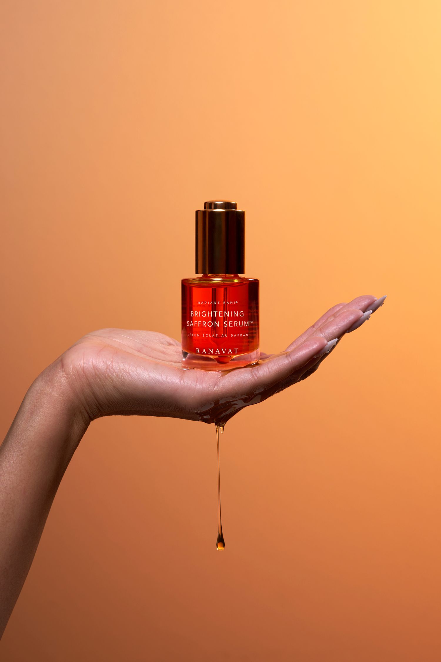 A hand holding a red glass bottle against an orange background while liquid drips from the bottom in a sequence of frames.